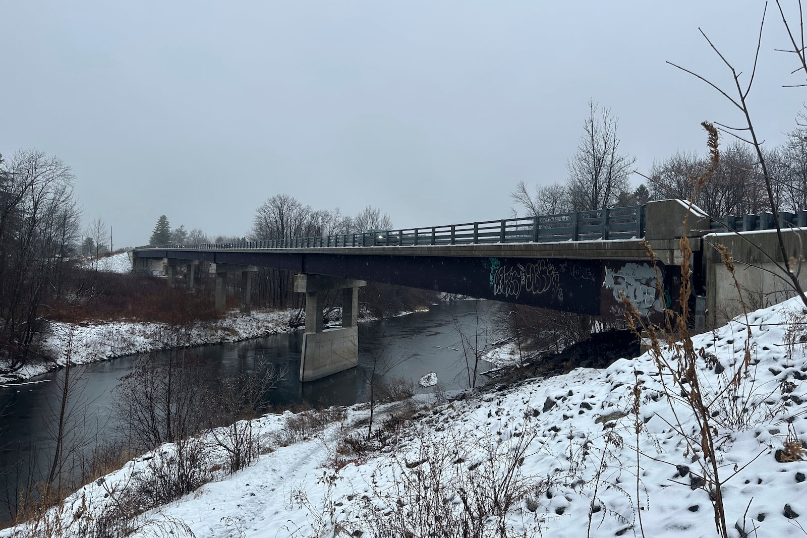 Rain and snow falls near the Presumpscot River in Falmouth, Maine as officials are watching for flooding on New England rivers, Wednesday, Dec. 11, 2024. (AP Photo/Patrick Whittle)