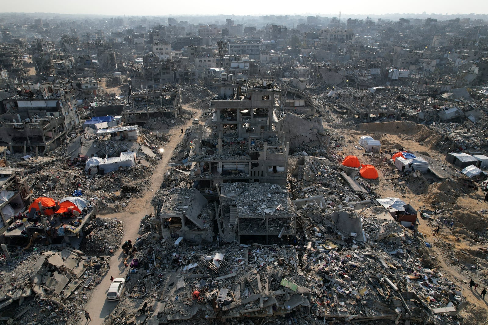 An aerial photograph taken by a drone shows tents amidst the destruction caused by the Israeli air and ground offensive in Beit Lahiya, northern Gaza Strip, on Monday, Feb. 17, 2025. (AP Photo/Mohammad Abu Samra)