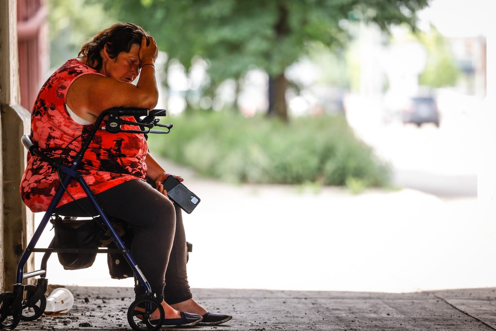 Dayton resident Sherry Griffin seeks shelter from the heat under the railroad trestle on South Patterson Blvd. on Monday June 13, 2022. Temperatures are expected to skyrocket into the 90s most of the week with heat indices in the 100s. JIM NOELKER/STAFF