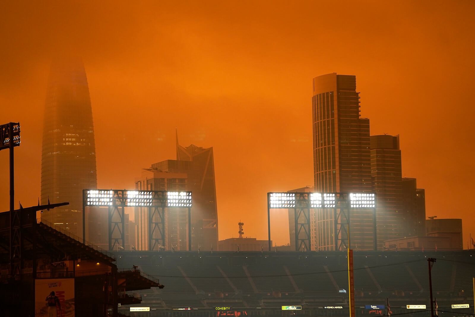 The skyline in the distance behind Oracle Park is partially visible with smoke from wildfires late Wednesday afternoon Sept. 9, 2020, in San Francisco. (AP Photo/Tony Avelar)