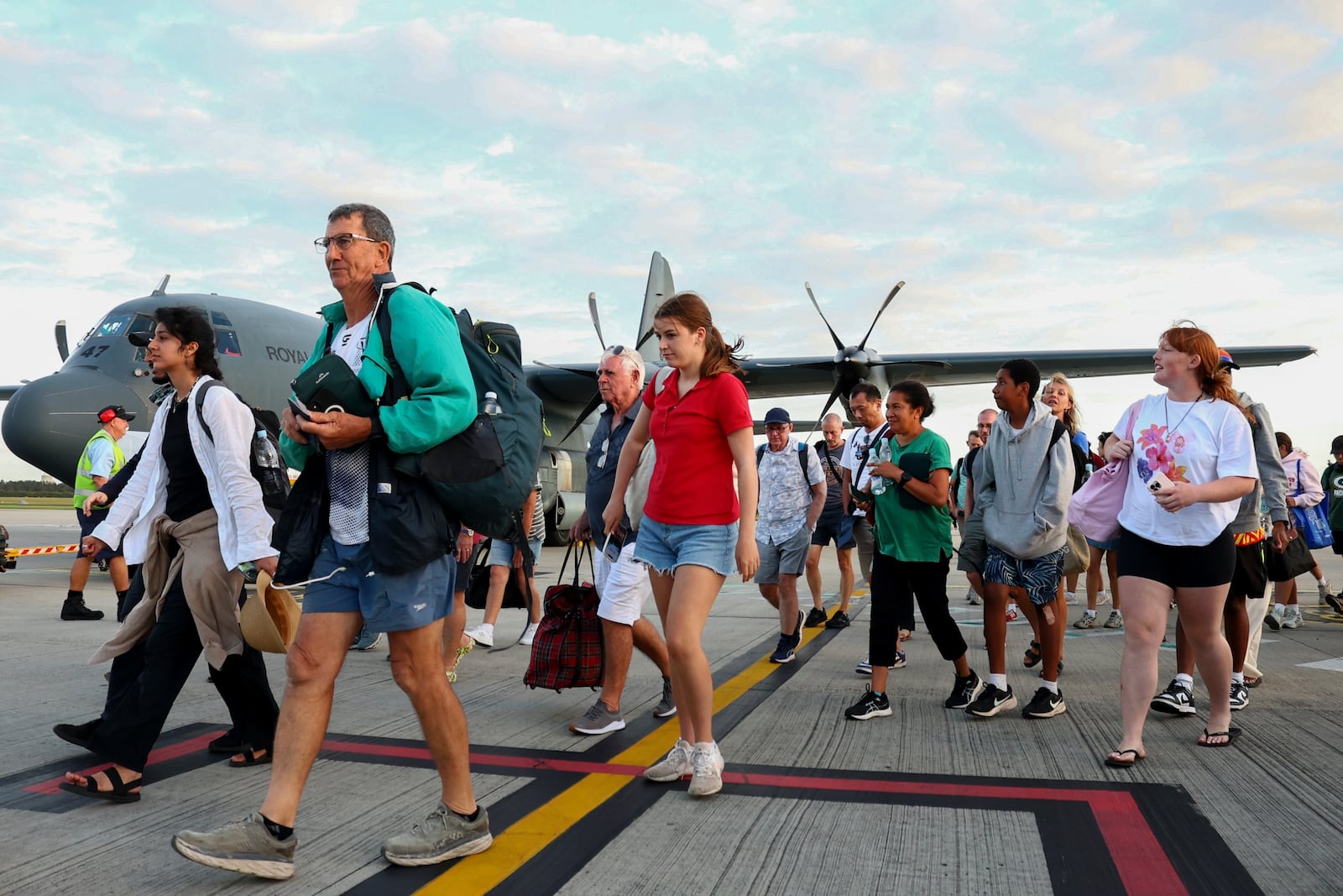 Australians stranded in Vanuatu following a powerful earthquake on Dec. 17, disembark from a Royal Australian Air Force plane at Brisbane International Airport in Brisbane, Australia, Thursday, Dec. 19, 2024. (David Clark/AAP Image via AP)