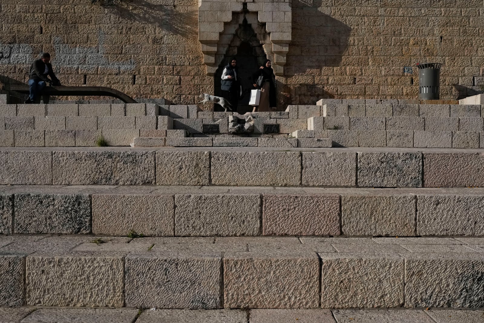 Women walk near the Damascus Gate outside Jerusalem's Old City, Tuesday, Dec. 3, 2024. (AP Photo/Matias Delacroix)