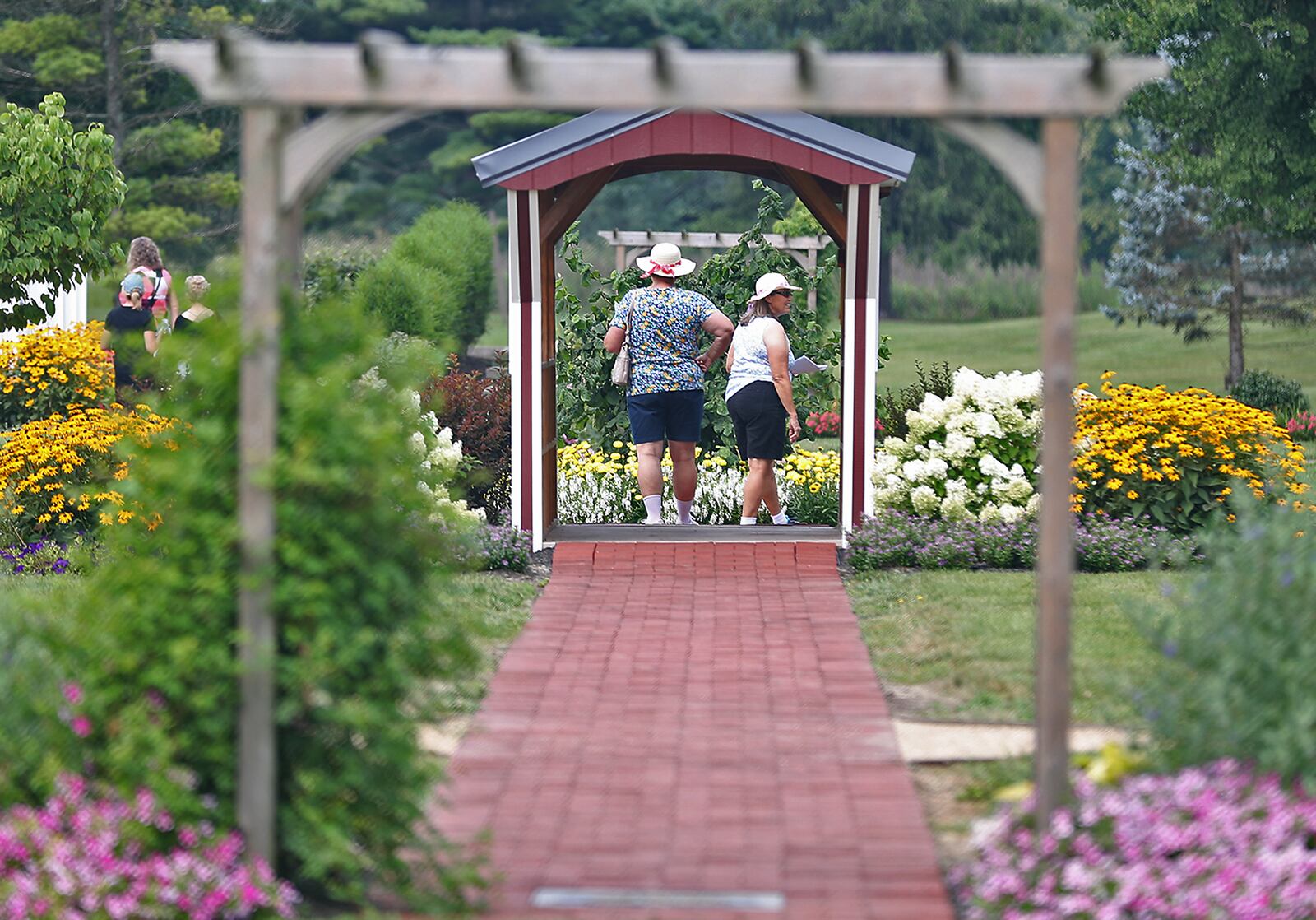 Visitors wonder through the Snyder Park Gardens and Arboretum during the Gardens' Jubilee celebrating their official grand opening Saturday. . BILL LACKEY/STAFF