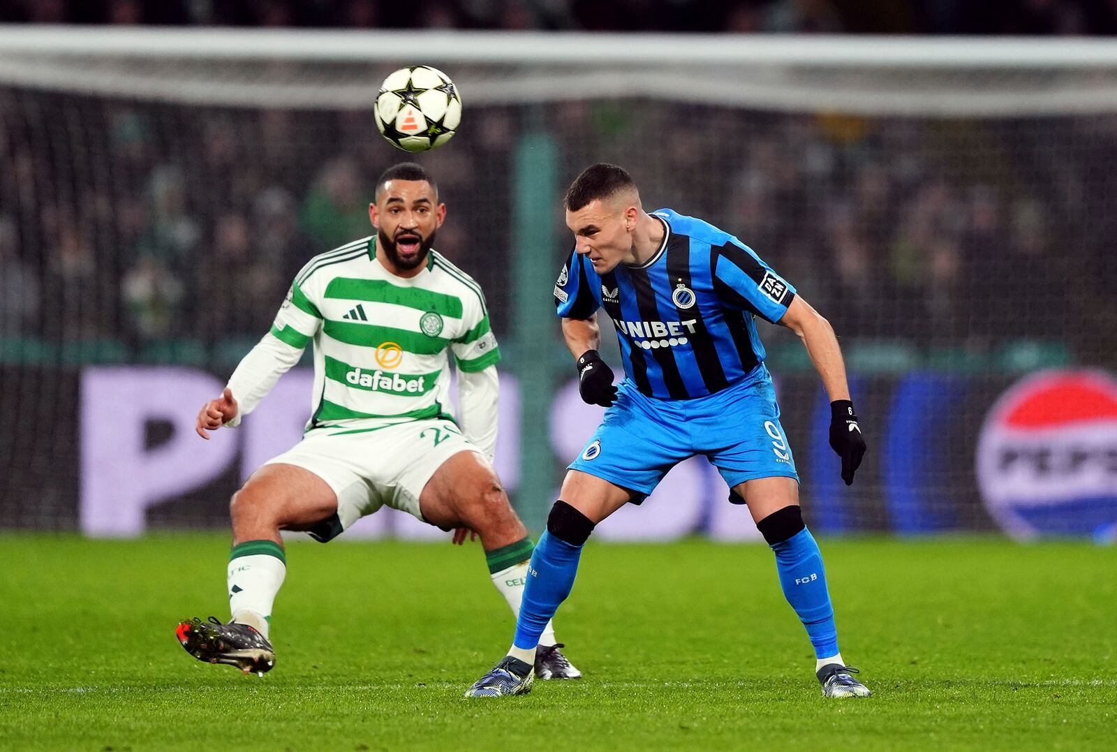 Celtic's Cameron Carter-Vickers, left, and Club Brugge's Ferran Jutgla in action during the UEFA Champions League opening phase soccer stage match at Celtic Park, Glasgow, Scotland, Wednesday Nov. 27, 2024. (Andrew Milligan/PA via AP)