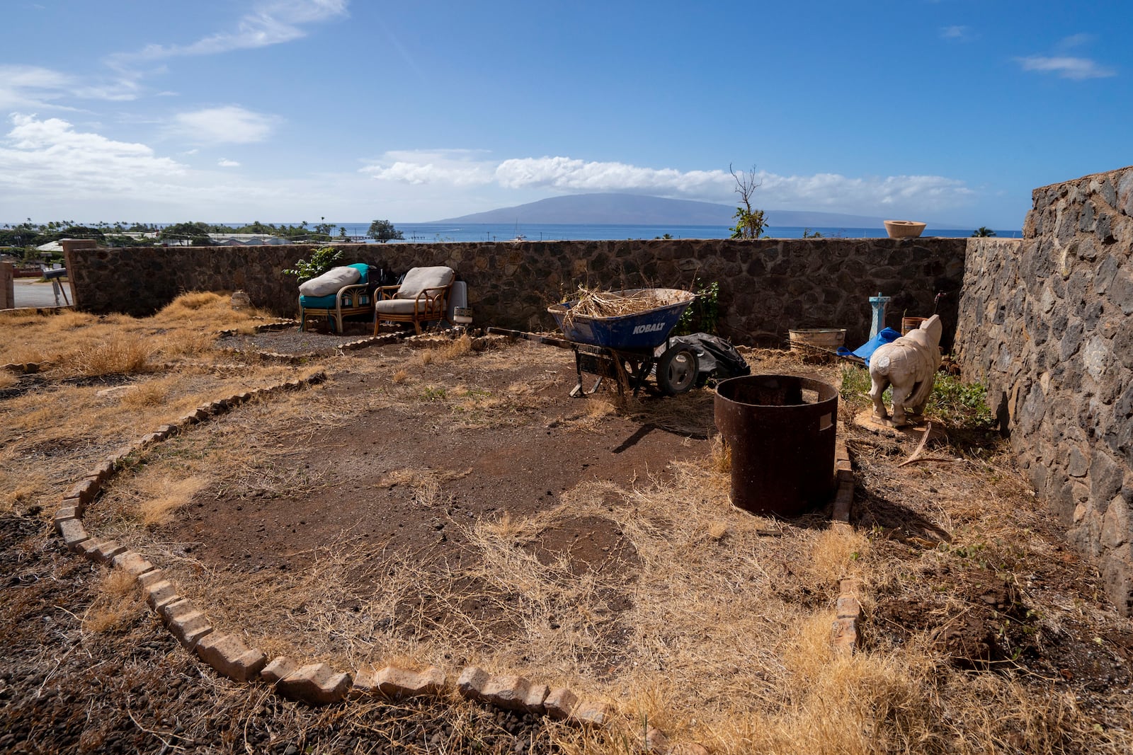 The lot where the four-bedroom house Tamara Akiona and her ten family members and friends used to live, is pictured, Thursday, Dec. 12, 2024, in Lahaina, Hawaii. The house burned down during last year's Lahaina wildfire. (AP Photo/Mengshin Lin)