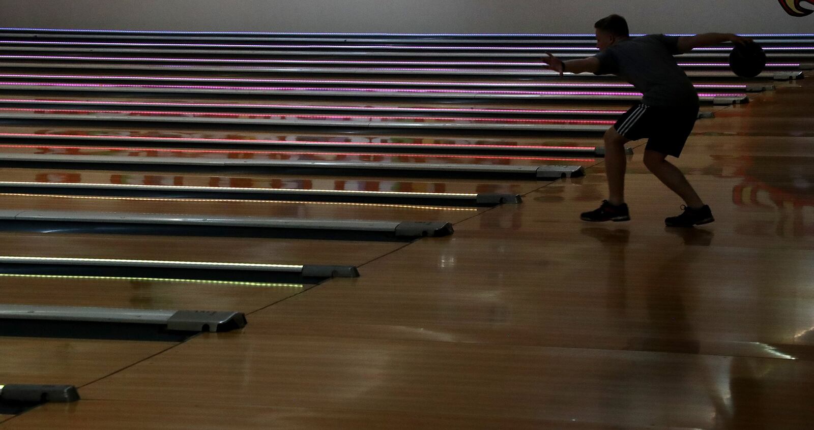 Jacob Schoening and his friends traveled from Huber Heights to Northridge Lanes to bowl Tuesday on the first day bowling alleys were allowed to reopen. BILL LACKEY/STAFF