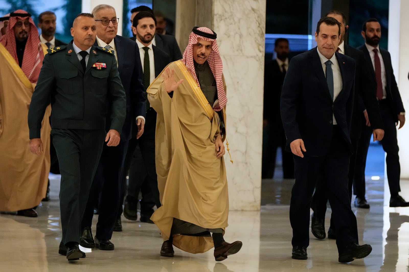 Saudi Arabia's Foreign Minister Prince Faisal bin Farhan al-Saud, center, waves to journalists upon his arrival to meet with Lebanese President Joseph Aoun at the presidential palace in Baabda, east of Beirut, Lebanon, Thursday, Jan. 23, 2025. (AP Photo/Hassan Ammar)