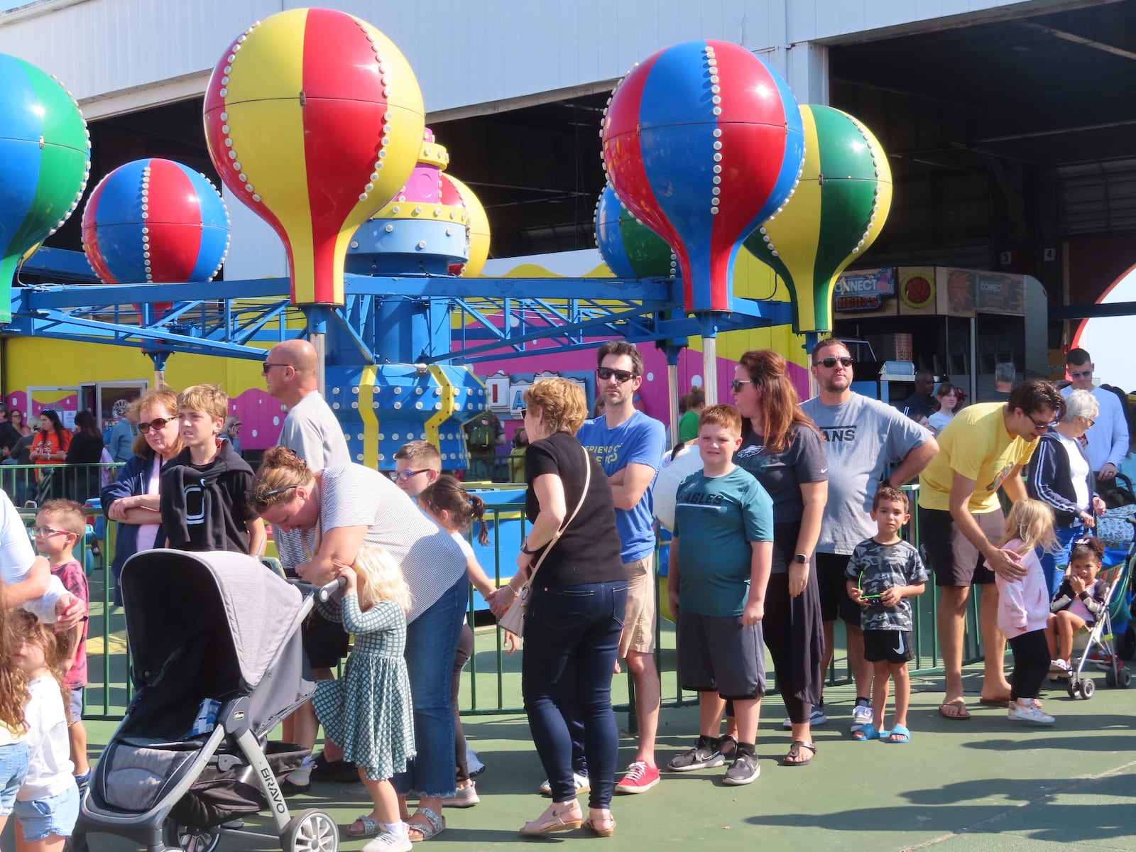 People wait in line to board rides at Gillian's Wonderland on the Ocean City N.J. boardwalk on Oct. 13, 2024, the popular amusement park's final day of operation before shutting down for good. (AP Photo/Wayne Parry)