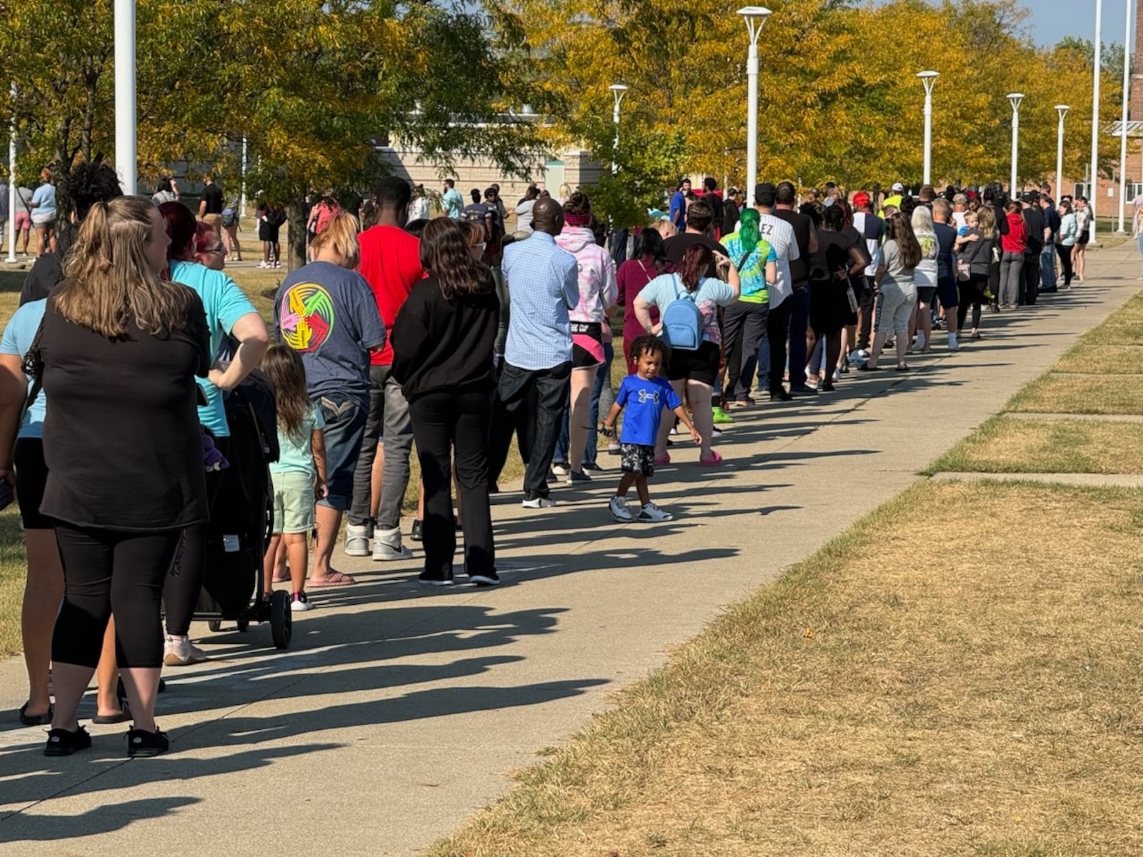 Parents wait in line at Springfield High School to pick up Simon Kenton Elementary students Monday. BILL LACKEY/STAFF