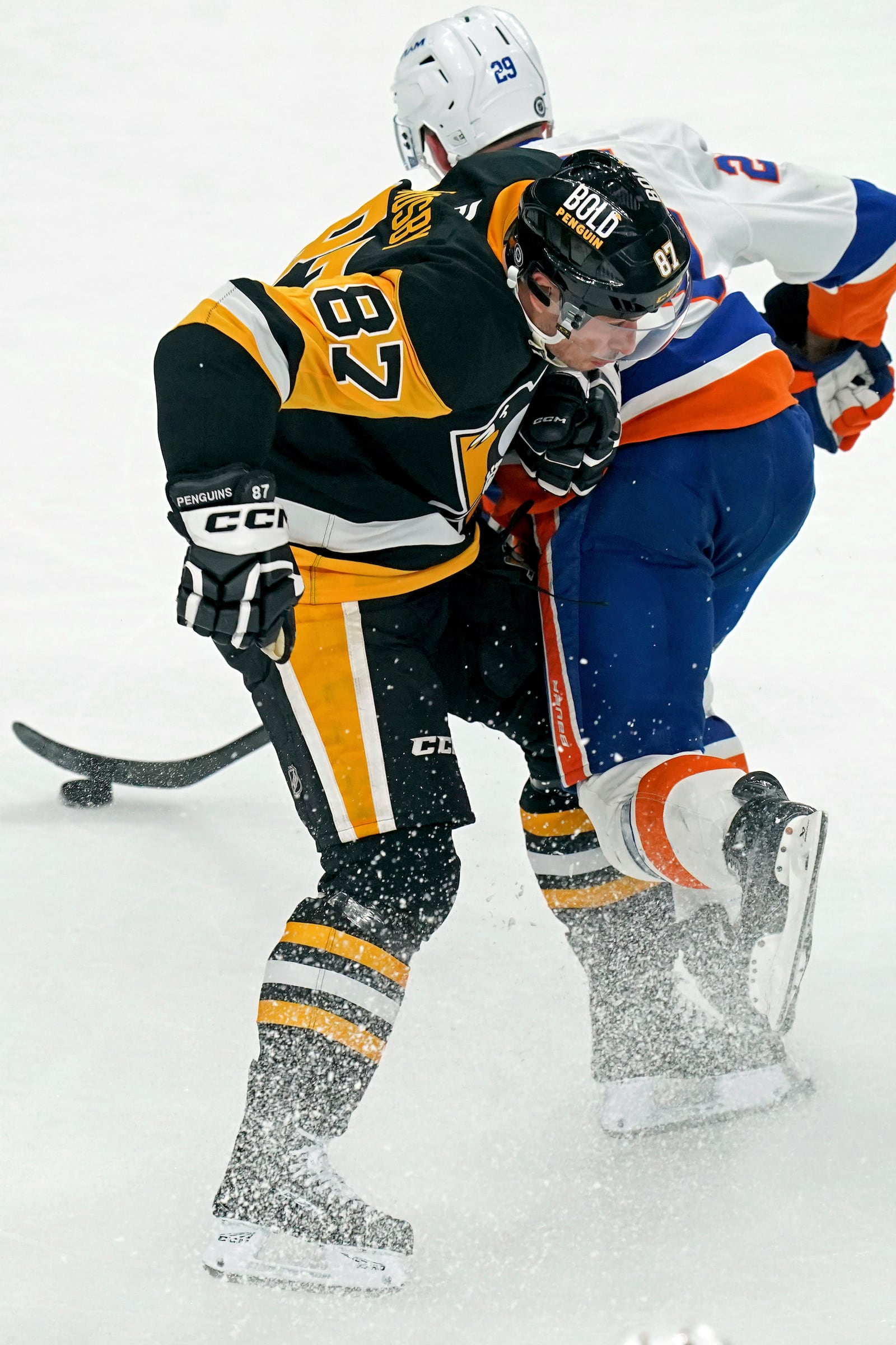 Pittsburgh Penguins' Sidney Crosby (87) collides with New York Islanders' Brock Nelson (29) during the first period of an NHL hockey game Sunday, Dec. 29, 2024, in Pittsburgh. (AP Photo/Matt Freed)