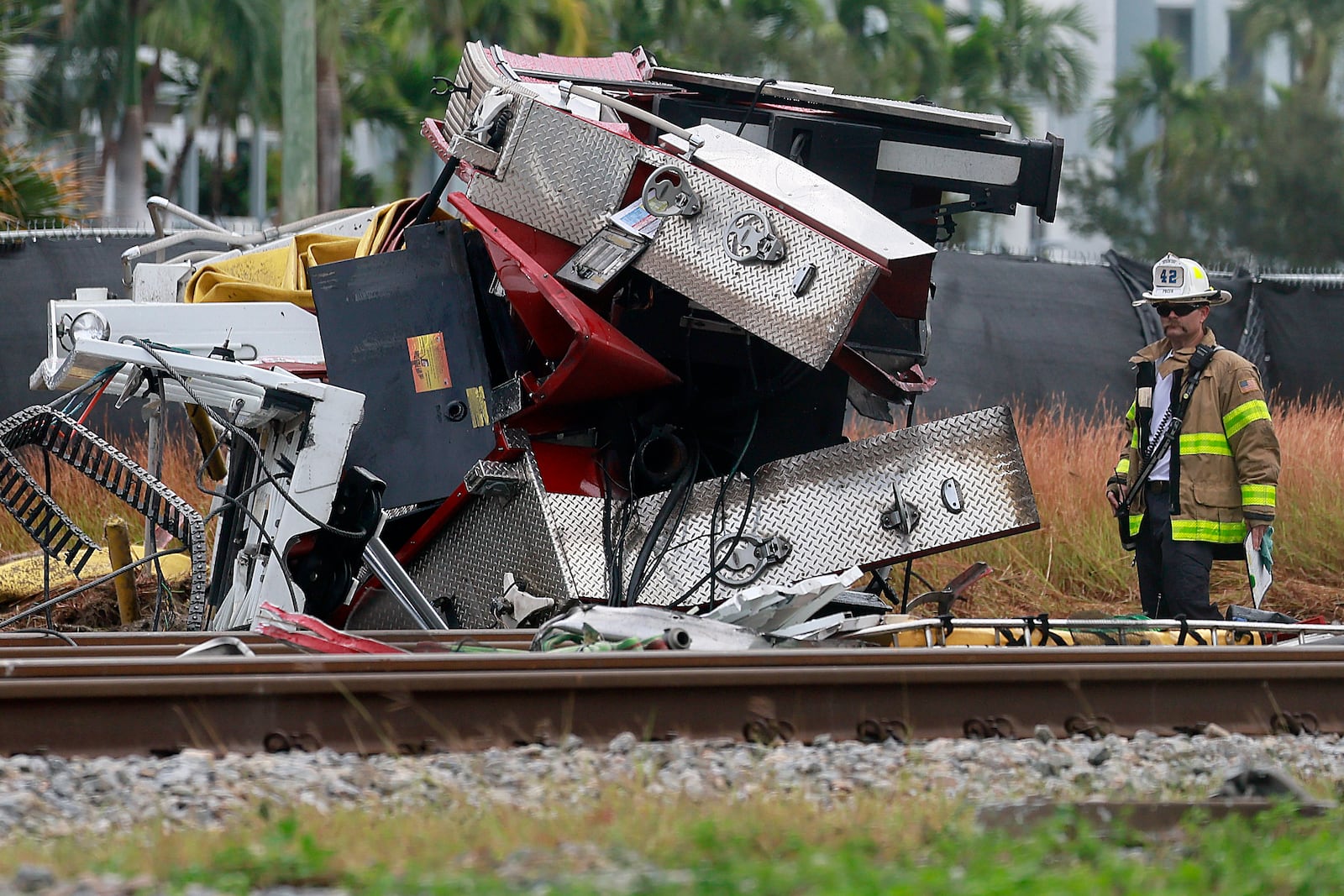 A fireman views damage after a Brightline train collided with a fire truck in downtown Delray Beach, Fla., Saturday, Dec. 28, 2024. (Mike Stocker/South Florida Sun-Sentinel via AP)