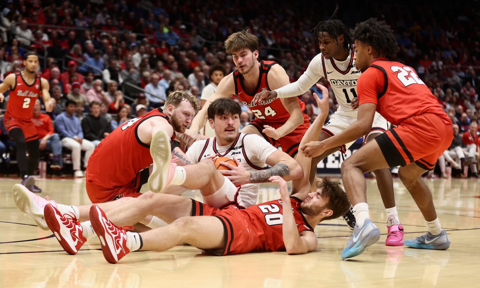 Dayton's Isaac Jack competes for a loose ball against Ball State on Wednesday, Nov. 13, 2024, at UD Arena. David Jablonski/Staff