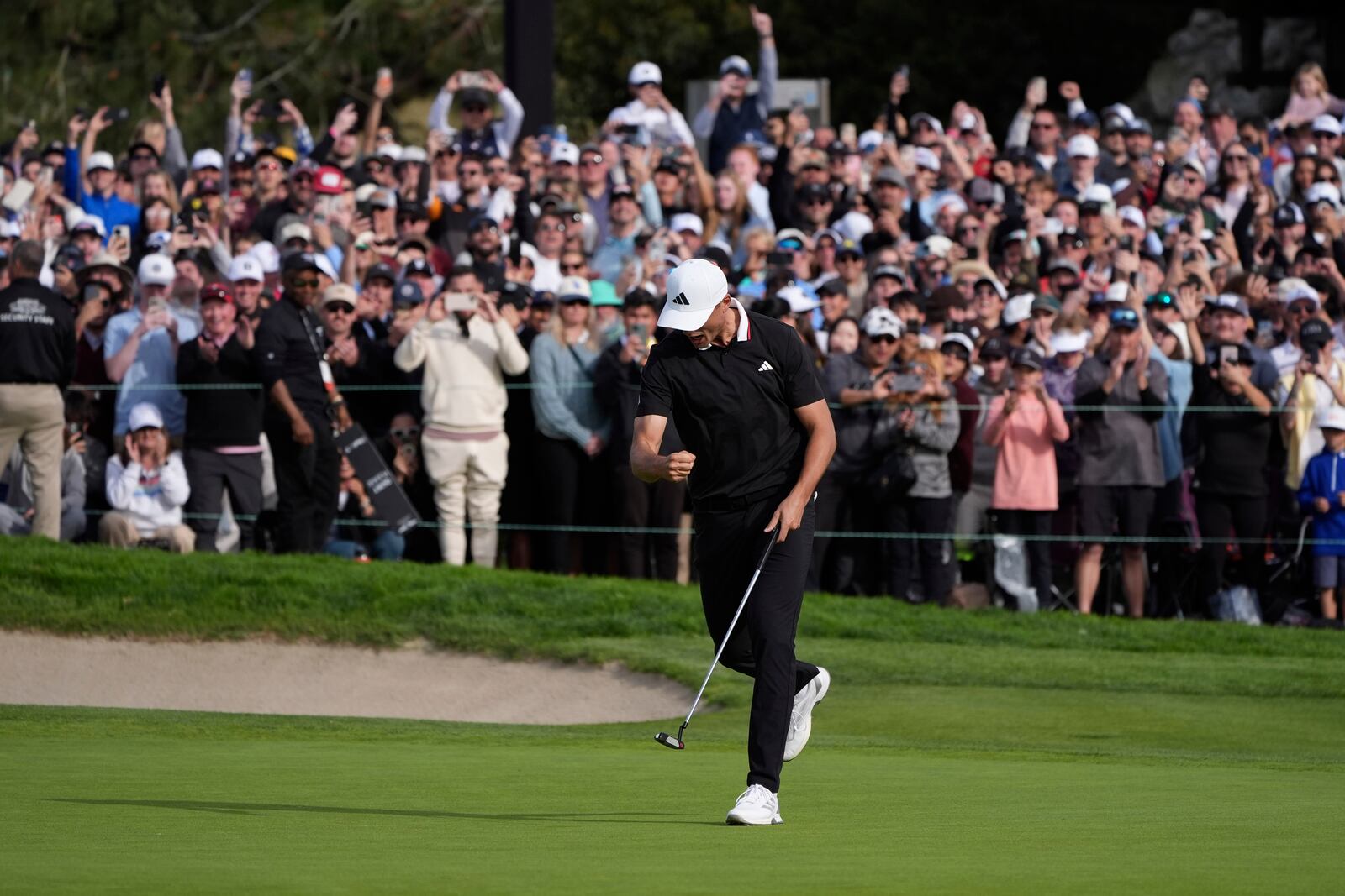 Ludvig Åberg, of Sweden, celebrates after making a birdie putt on the 18th green of the South Course at Torrey Pines during the final round of the Genesis Invitational golf tournament Sunday, Feb. 16, 2025, in San Diego. (AP Photo/Gregory Bull)