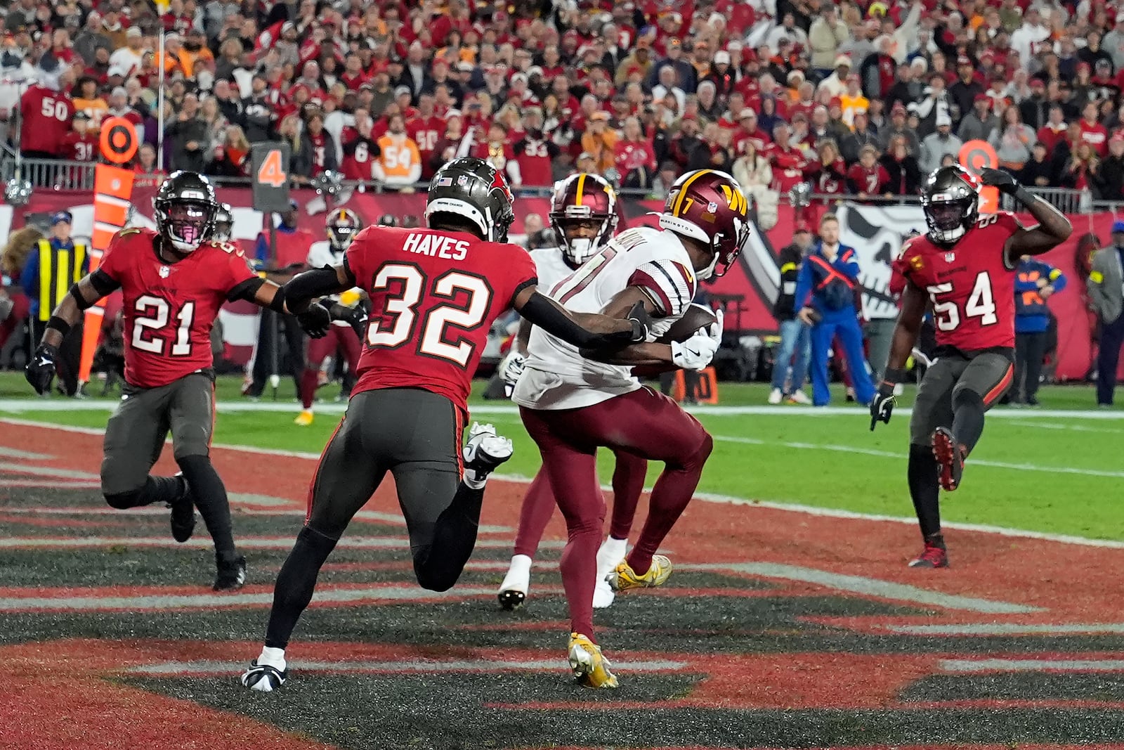 Washington Commanders wide receiver Terry McLaurin, middle, catches a touchdown pass in front of Tampa Bay Buccaneers safety Josh Hayes (32) during the second half of an NFL wild-card playoff football game in Tampa, Fla., Sunday, Jan. 12, 2025. (AP Photo/Chris O'Meara)