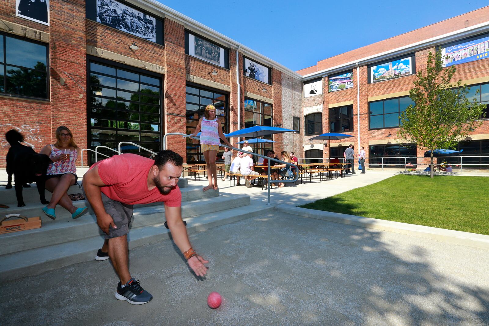 Fernando Romero plays boche ball in the beer garden at the new Mother Stewarts Brewing Co. Friday afternoon. After working for more than a year to rehab an old warehouse in downtown, the brewery finally open to the public Friday, July 15, 2016. Bill Lackey/Staff