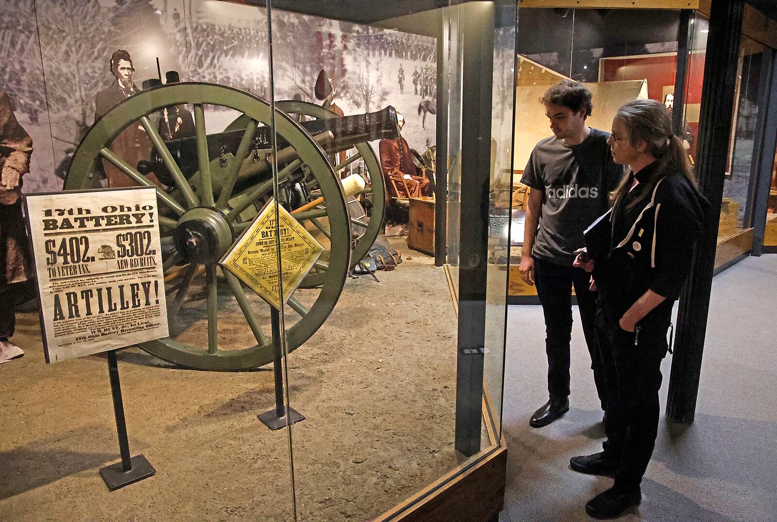 The staff at the Clark County Historical Society walks through the military gallery in the Clark County Heritage Center museum Thursday, Dec. 28, 2023 as they plan how they're going to remove some of the items from display cases so the fire suppression system can be undated while the museum is closed in January. BILL LACKEY/STAFF