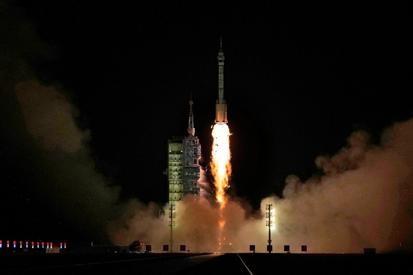 A Long March rocket with a Shenzhou-19 spacecraft atop takes off from the Jiuquan Satellite Launch Center in Jiuquan, northwestern China in the early hours of Wednesday, Oct. 30, 2024. (AP Photo/Ng Han Guan)