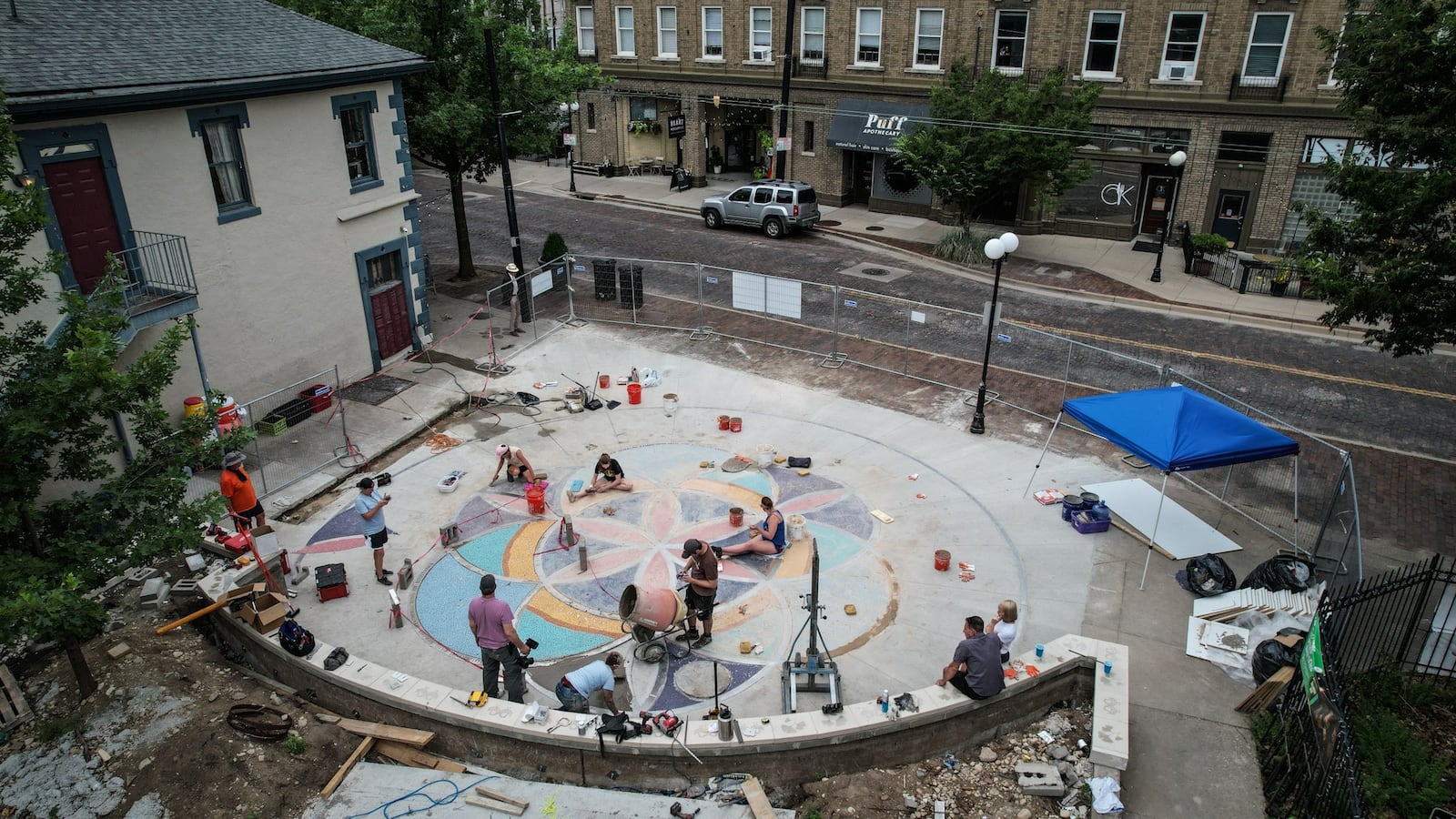 The Mosaic Institute along with volunteers are installing the largest ground mosaic the organization has ever created on 5th Street in the Oregon District. JIM NOELKER/STAFF