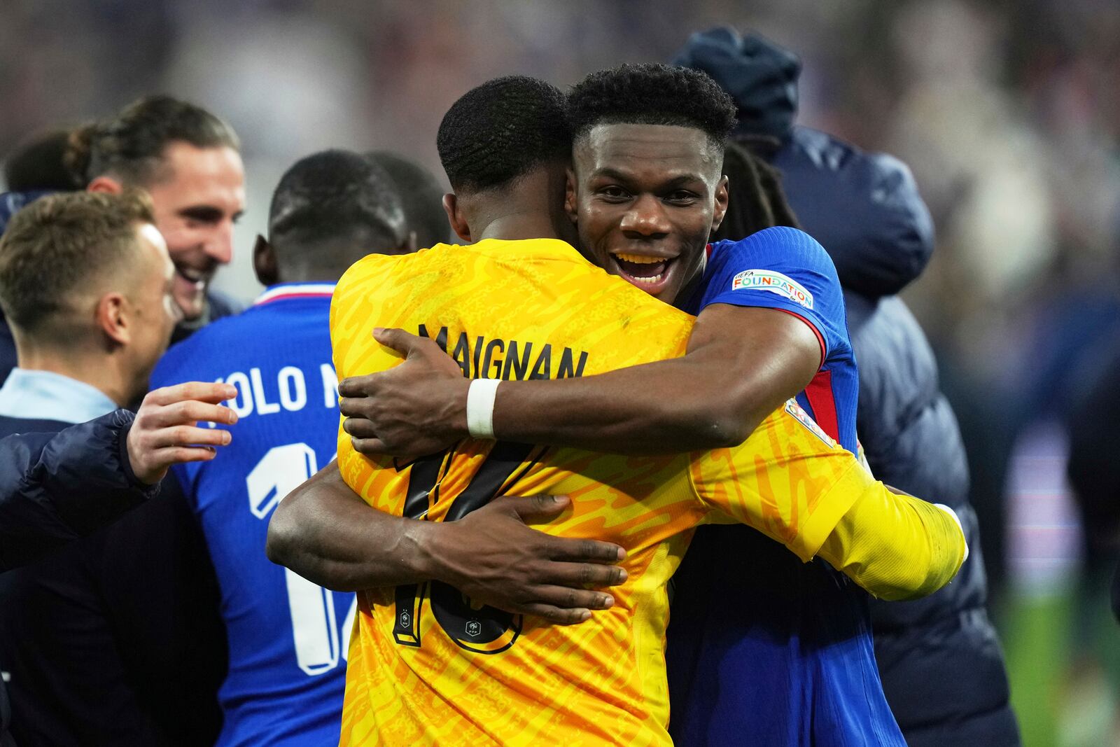 France's goalkeeper Mike Maignan, front, and Aurelien Tchouameni celebrate after winning the penalty shootout during the UEFA Nations League quarterfinal second leg soccer match between France and Croatia, at the Stade de France in Saint-Denis, outside Paris, Sunday, March 23, 2025. (AP Photo/Thibault Camus)