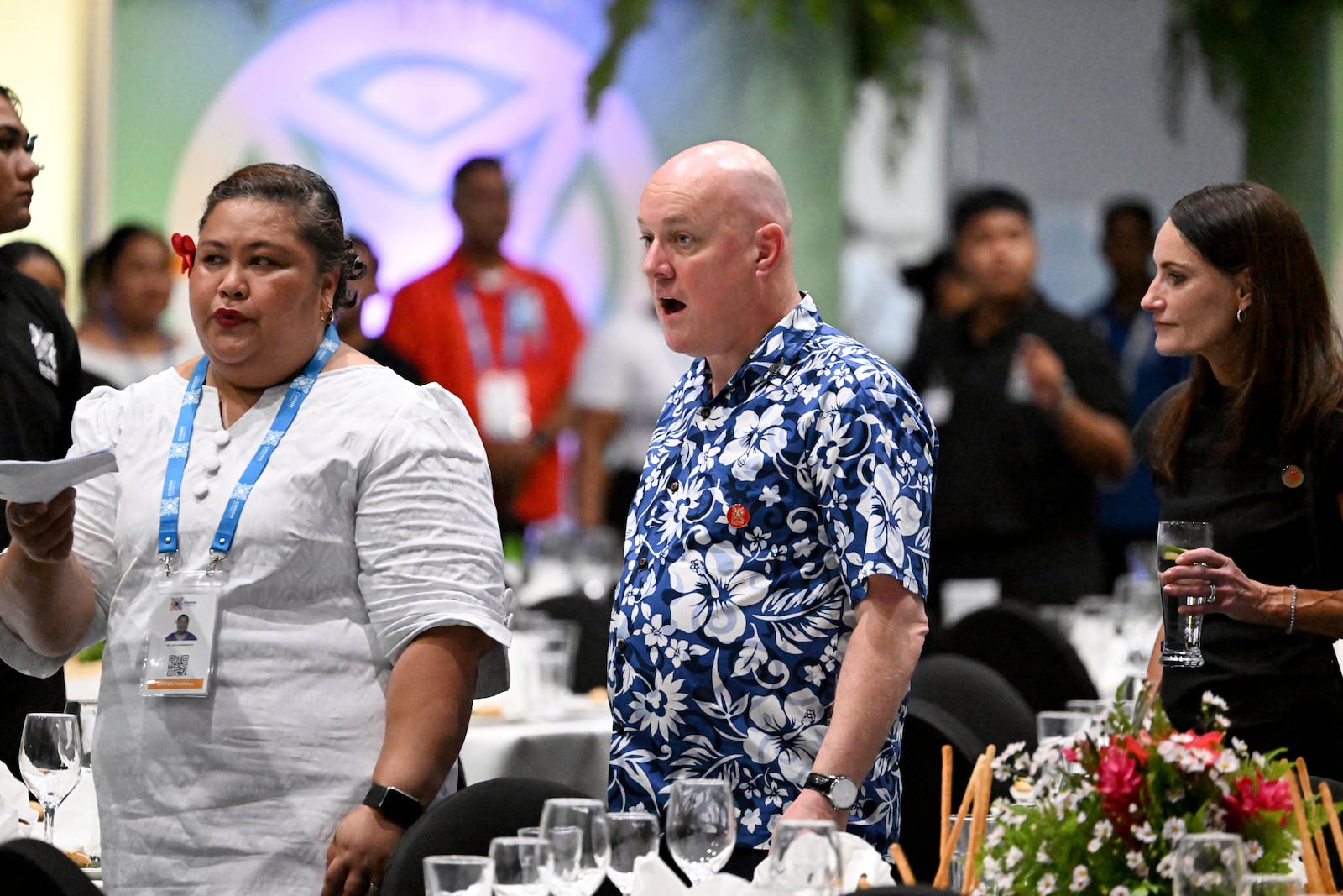 New Zealand's Prime Minister Christopher Luxon, center, and his wife Amanda, right, attend a State Banquet during the Commonwealth Heads of Government Meeting (CHOGM) in Apia, Samoa, on Thursday, Oct. 24, 2024. (William West/Pool Photo via AP)