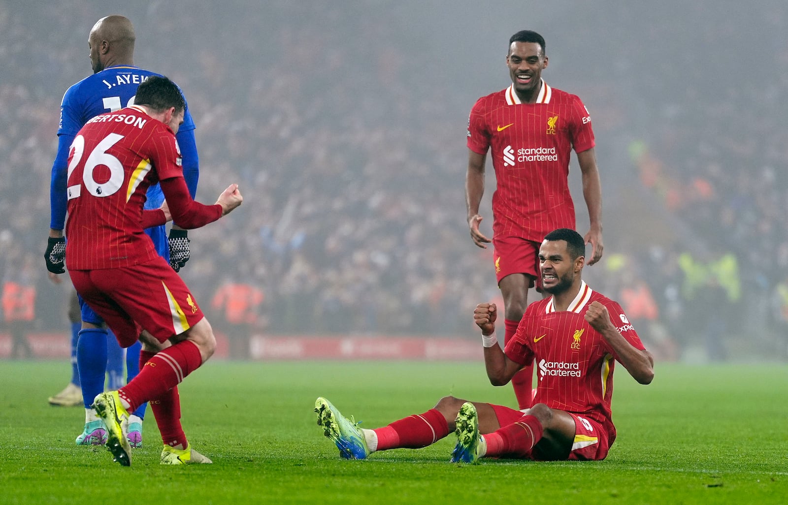 Liverpool's Cody Gakpo, right, celebrates with teammates after scoring his side's first goal against Leicester City during the English Premier League soccer match at the Anfield stadium in Liverpool, Thursday, Dec. 26, 2024. (Peter Byrne/PA via AP)