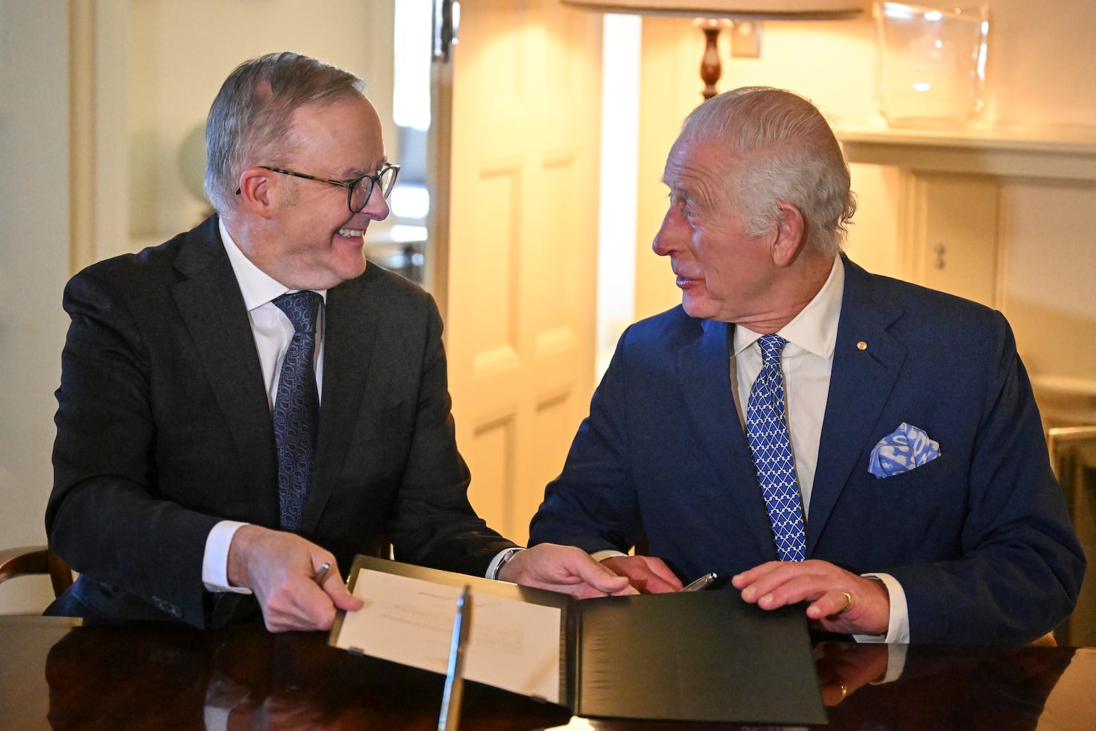 Britain's King Charles III and Australia's Prime Minister Anthony Albanese sign royal warrants granting the Great Seal of Australia at Government House in Canberra, Australia, Monday, Oct. 21, 2024. (Saeed Khan/Pool Photo via AP)