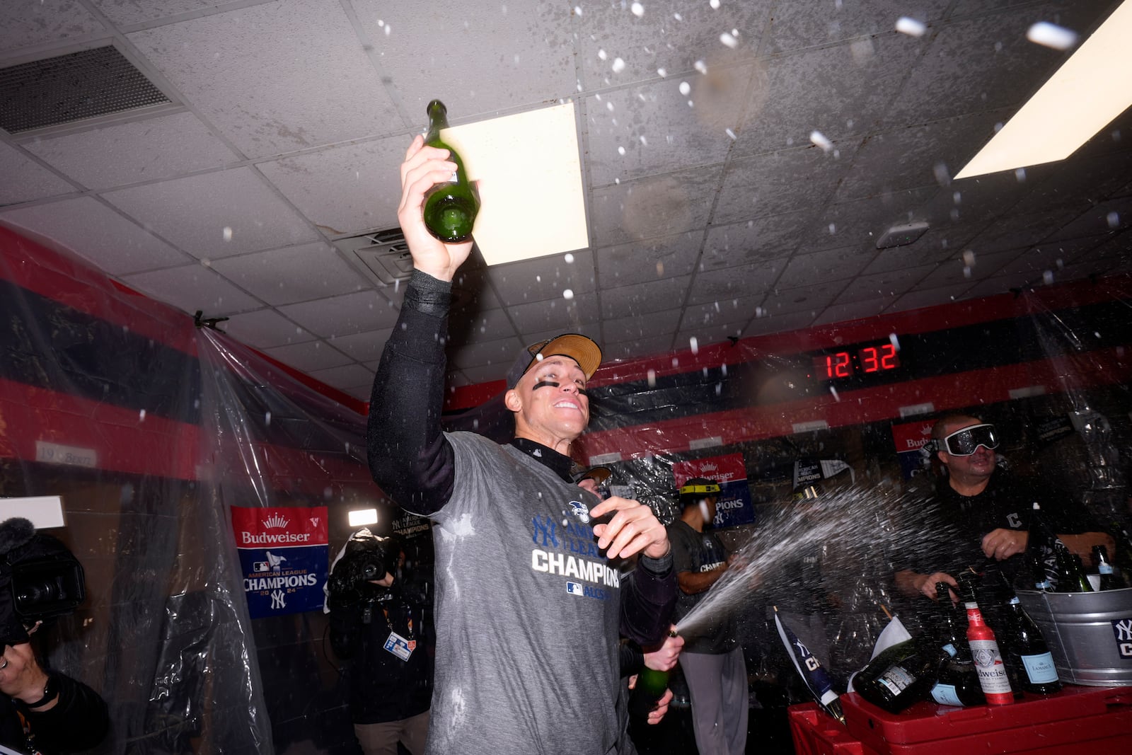 New York Yankees' Aaron Judge celebrates in the clubhouse after Game 5 of the baseball AL Championship Series against the Cleveland Guardians Sunday, Oct. 20, 2024, in Cleveland. The Yankees won 5-2 to advance to the World Series. (AP Photo/Godofredo A. Vásquez )