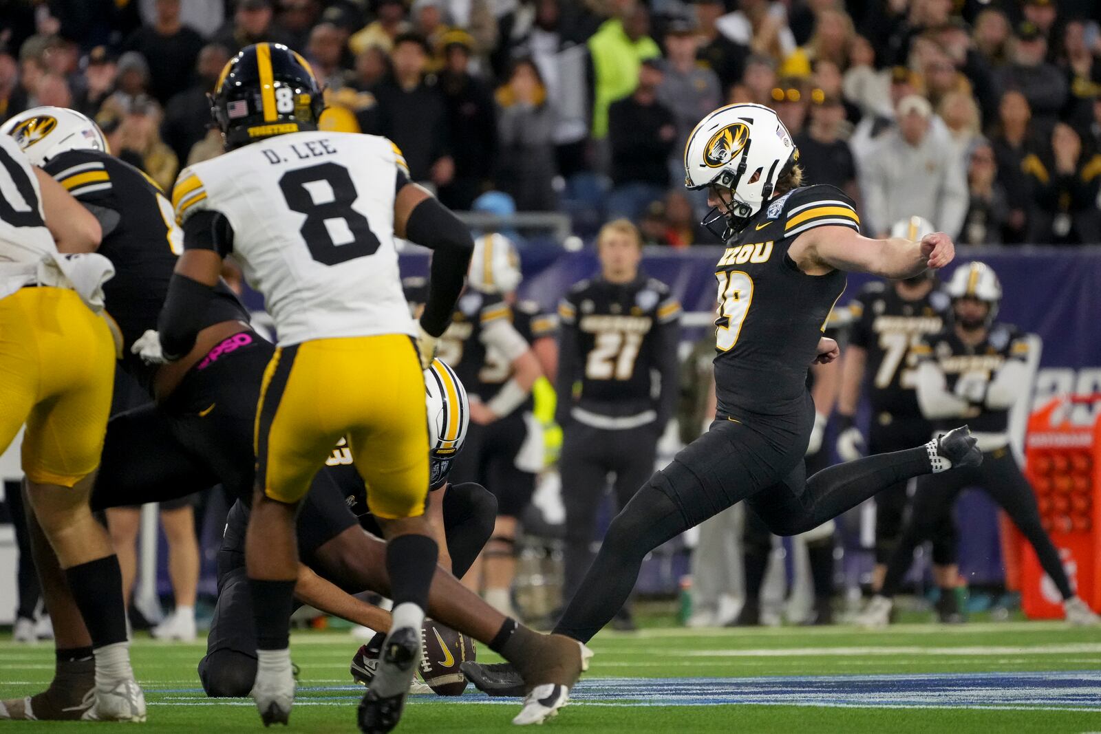 Missouri place-kicker Blake Craig, right, kicks a 56 yard field goal during the second half of the Music City Bowl NCAA college football game against Iowa, Monday, Dec. 30, 2024, in Nashville, Tenn. Missouri won 27-24. (AP Photo/George Walker IV)