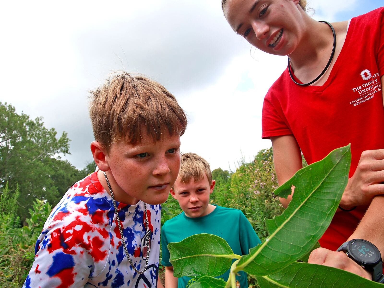 Mary Kate Mark shows Patrick and Robbie Mitchell some insects in the pollinator garden during the Snyder Park Gardens and Arboretum's Garden Jubilee event. BILL LACKEY/STAFF