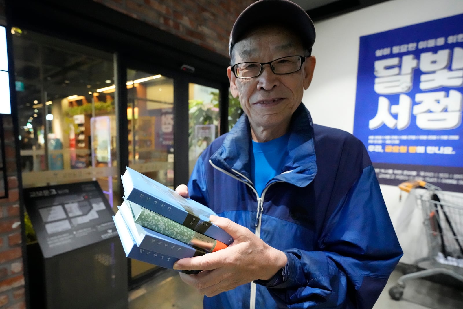 77-year-old South Korean Kim Hyung-duk poses after buying South Korean author Han Kang's books at a bookstore in Goyang, South Korea, Thursday, Oct. 10, 2024. (AP Photo/Lee Jin-man)