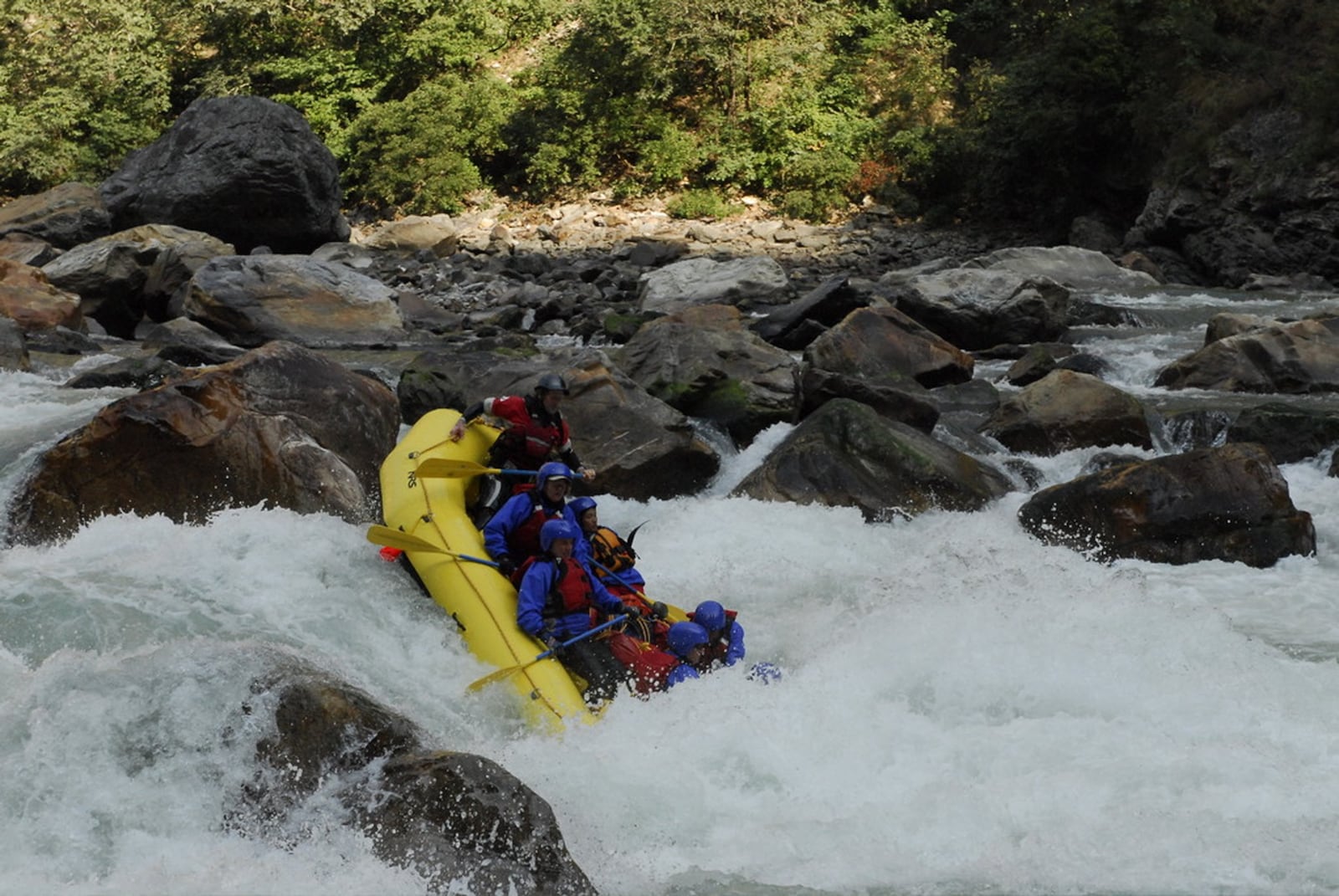 Larry Connor (on the end of the raft submegred in water with only the tip of his helmet showing) make the first-ever descent of the Drangme Chhu River in the Himalaya Mountains in Bhutan. CONTRIBUTED PHOTO