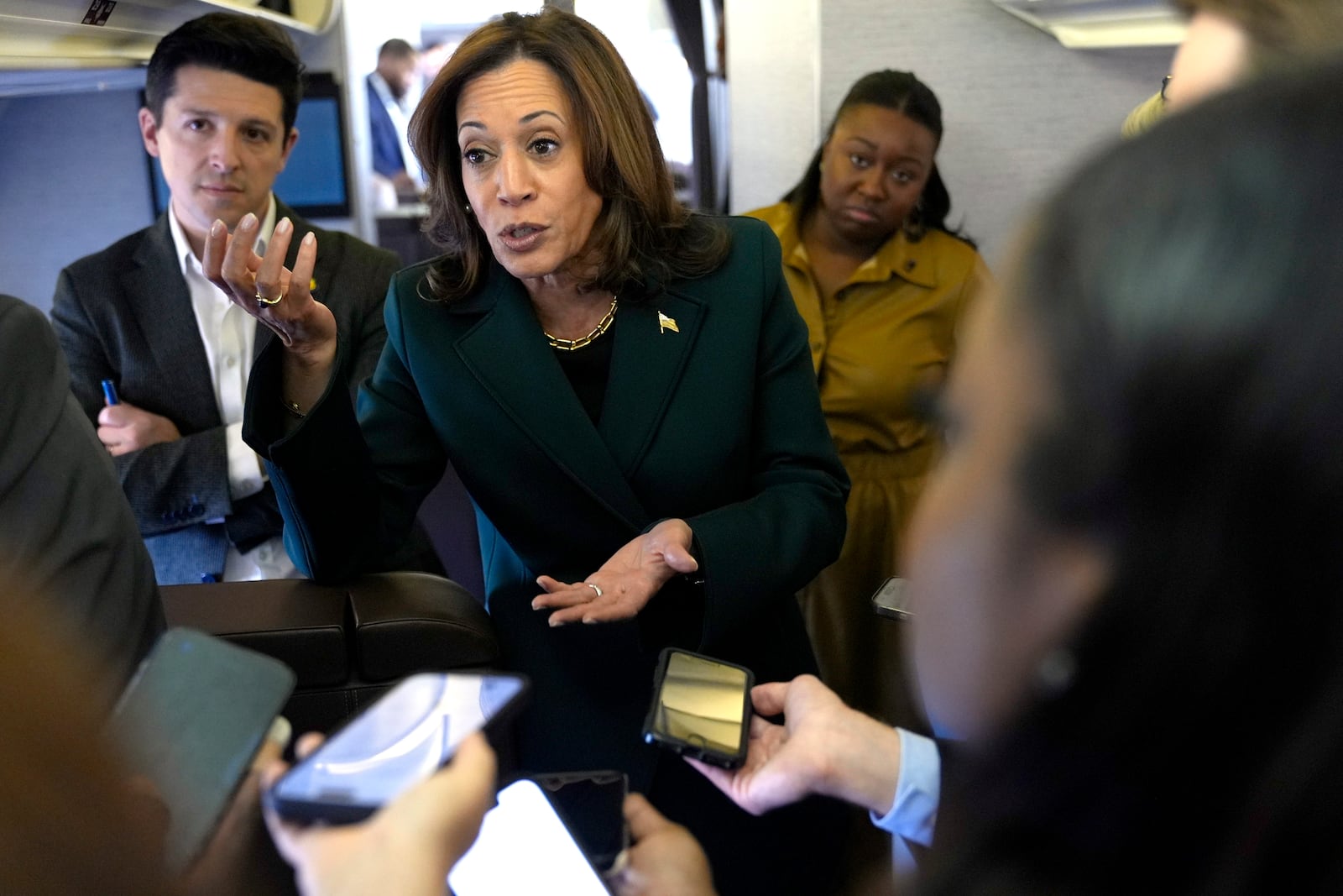 Democratic presidential nominee Vice President Kamala Harris speaks with members of the press on board Air Force Two at Philadelphia International Airport, Monday, Oct. 21, 2024, in Philadelphia, before departing to Michigan. (AP Photo/Jacquelyn Martin, Pool)