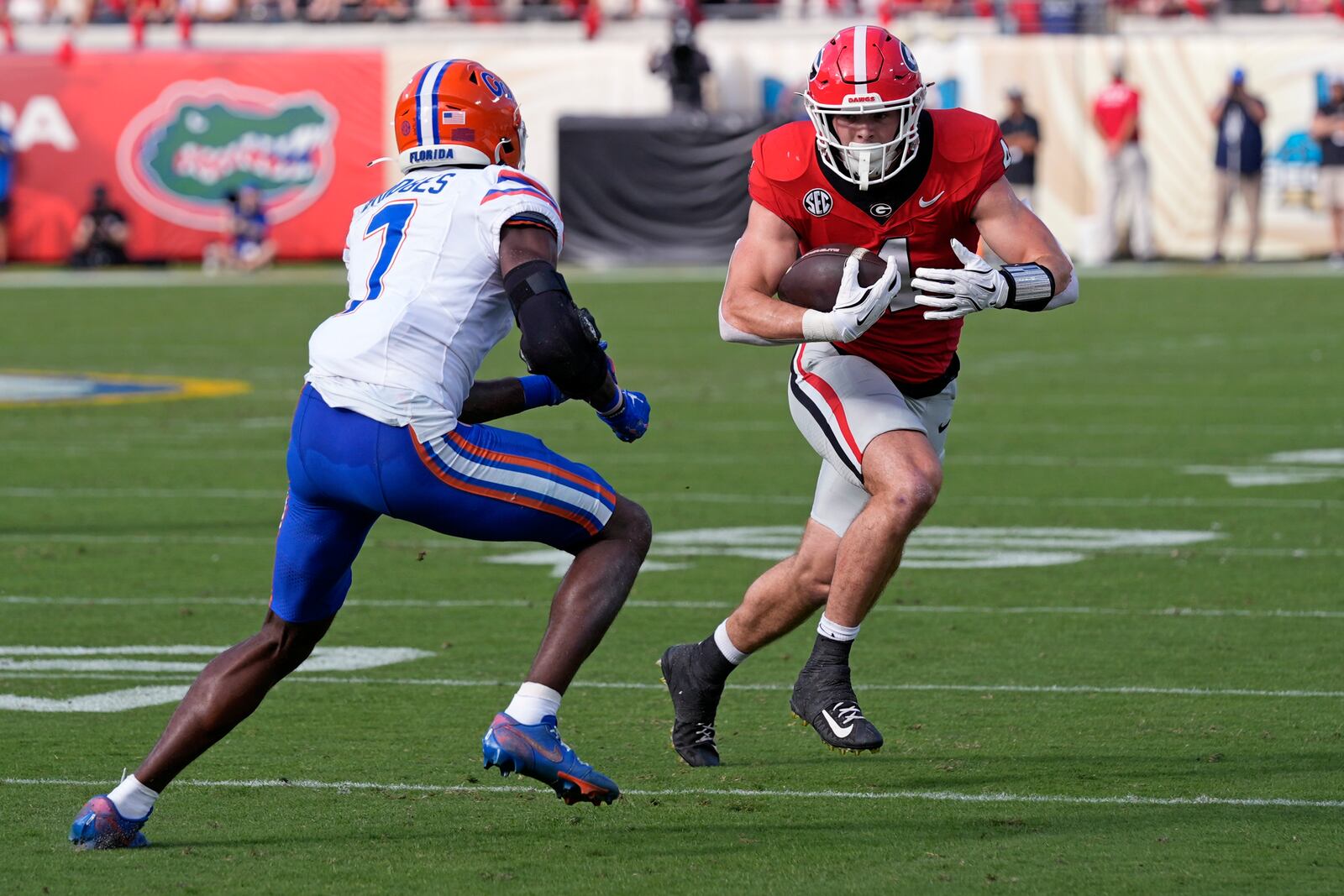 Georgia tight end Oscar Delp, right, tries to get past Florida defensive back Trikweze Bridges (7) after a reception during the first half of an NCAA college football game, Saturday, Nov. 2, 2024, in Jacksonville, Fla. (AP Photo/John Raoux)