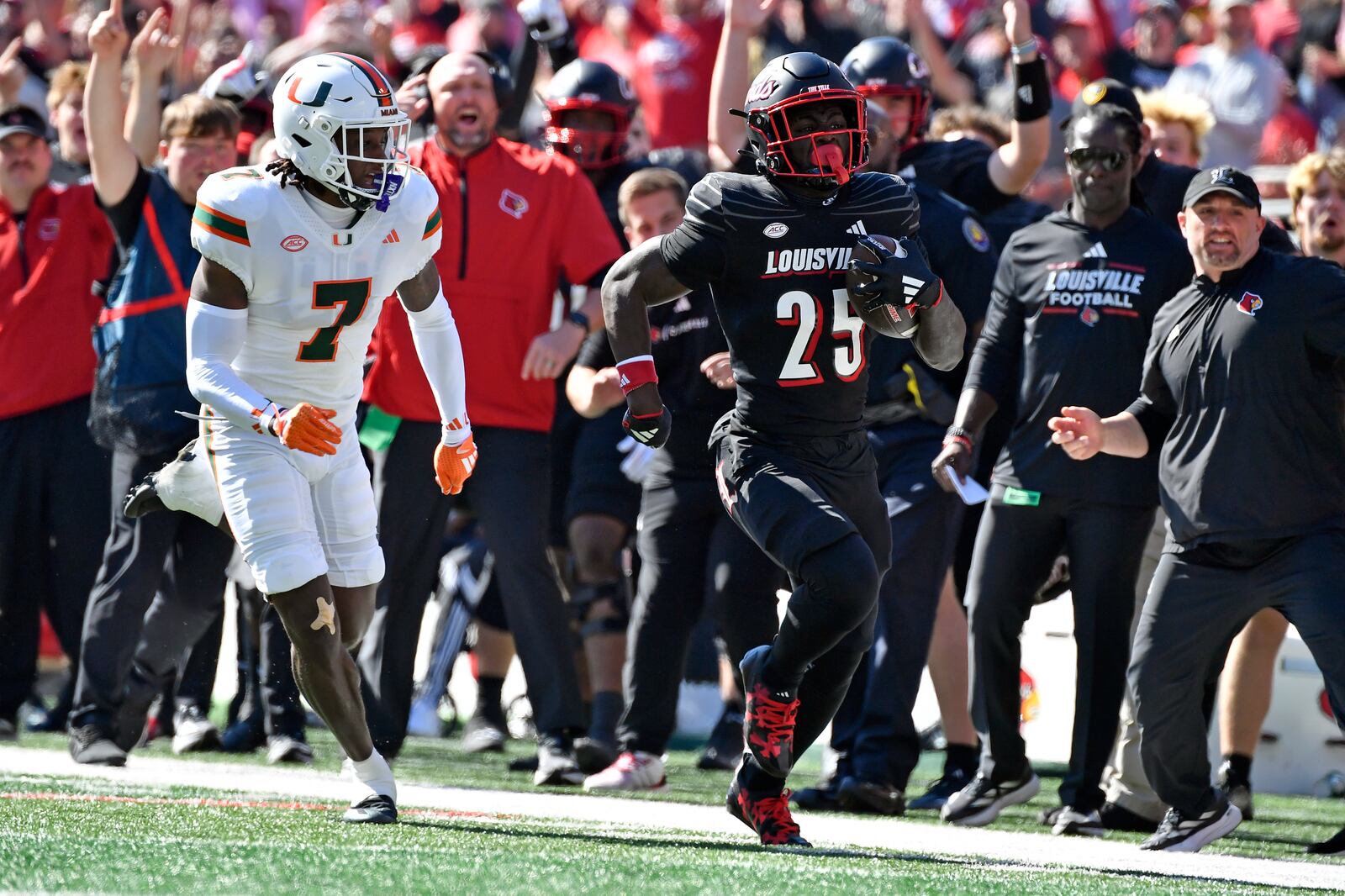 Louisville running back Isaac Brown (25) runs from the pursuit of Miami defensive back Jaden Harris (7) to score during the first half of an NCAA college football game in Louisville, Ky., Saturday, Oct. 19, 2024. (AP Photo/Timothy D. Easley)