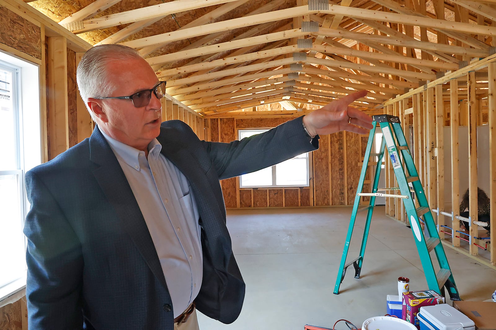 Greg Womacks, executive director of Neighborhood Housing Partnership of Greater Springfield, talks about the layout of one of the three new houses their building on Clifton Avenue Tuesday, August 8, 2023. BILL LACKEY/STAFF