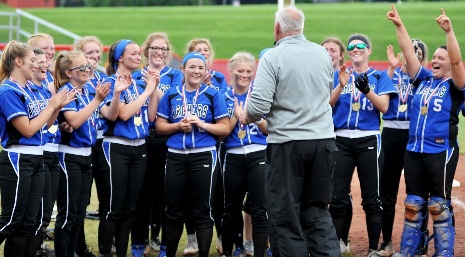 Ohio High School Athletic Association executive director Jerry Snodgrass talks to the Antwerp Archers on Sunday after they defeated Mechanicsburg 5-0 to win the Division IV state softball championship at Firestone Stadium in Akron. RICK CASSANO/STAFF