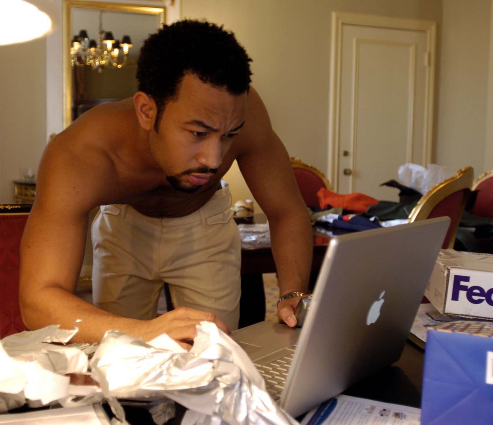 John Legend checks his laptop in his Los Angeles hotel room before going to the Grammy Awards in 2006. MARSHALL GORBY / STAFF