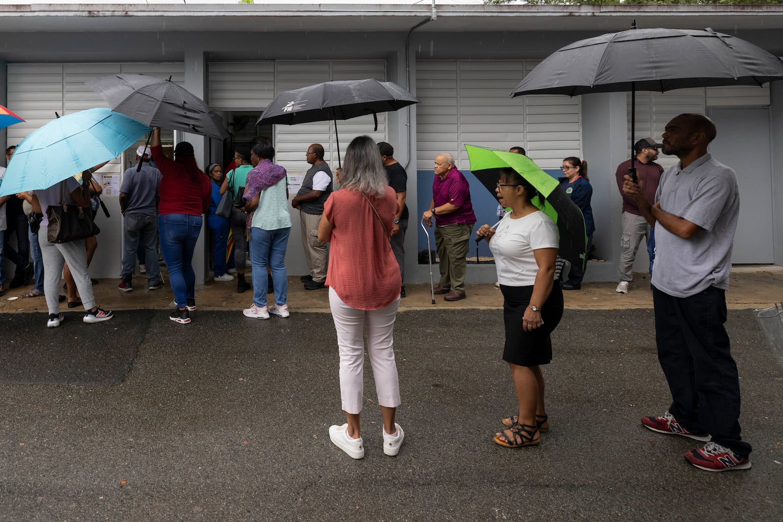 Voters line up at a polling station during general elections in San Juan, Puerto Rico, Tuesday, Nov. 5, 2024. (AP Photo/Alejandro Granadillo)