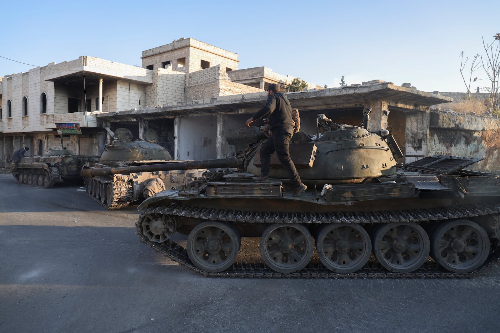 Syrian opposition fighters manoeuvre using armoured vehicles seized from the Syrian army in the town of Maarat al-Numan, south of Idlib, Syria, Tuesday Dec. 3, 2024.(AP Photo/Omar Albam)