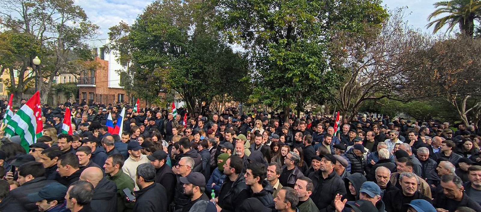 In this photo taken from video released by AIASHARA Independent Agency, Protesters gather outside the parliament building of the Georgian separatist region of Abkhazia as tensions flared over a proposed pact that would allow Russians to buy apartments in the region, Georgia, on Friday, Nov. 15, 2024. (AIASHARA Independent Agency via AP)