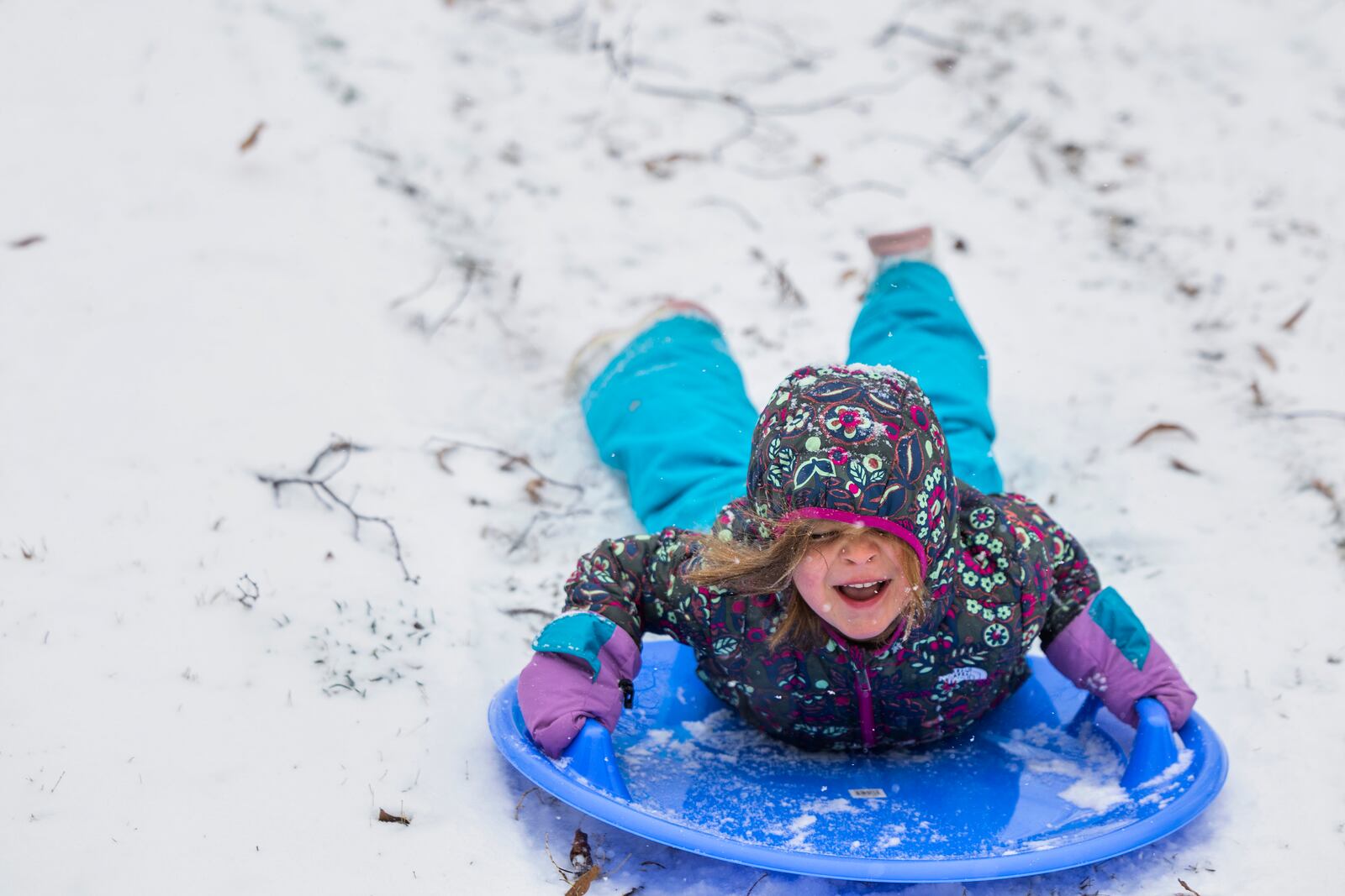 Polly Mae Pollock, 5, sleds down a hill at Byrd Park, Wednesday, Feb. 19, 2025, in Richmond, Va. (Margo Wagner/Richmond Times-Dispatch via AP)