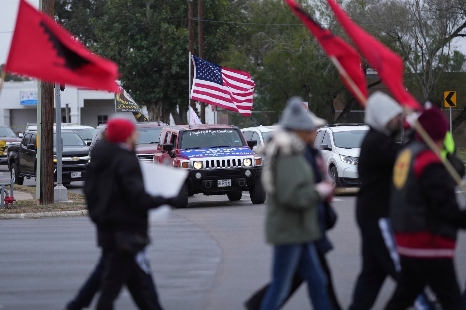 Supporters of President-elect Donald Trump honk as they watch a group from La Union del Pueblo Entero (LUPE), meaning The Union of the Entire People, marching to protest the inauguration of President-elect Trump, Monday, Jan. 20, 2025, in McAllen, Texas. (AP Photo/Eric Gay)