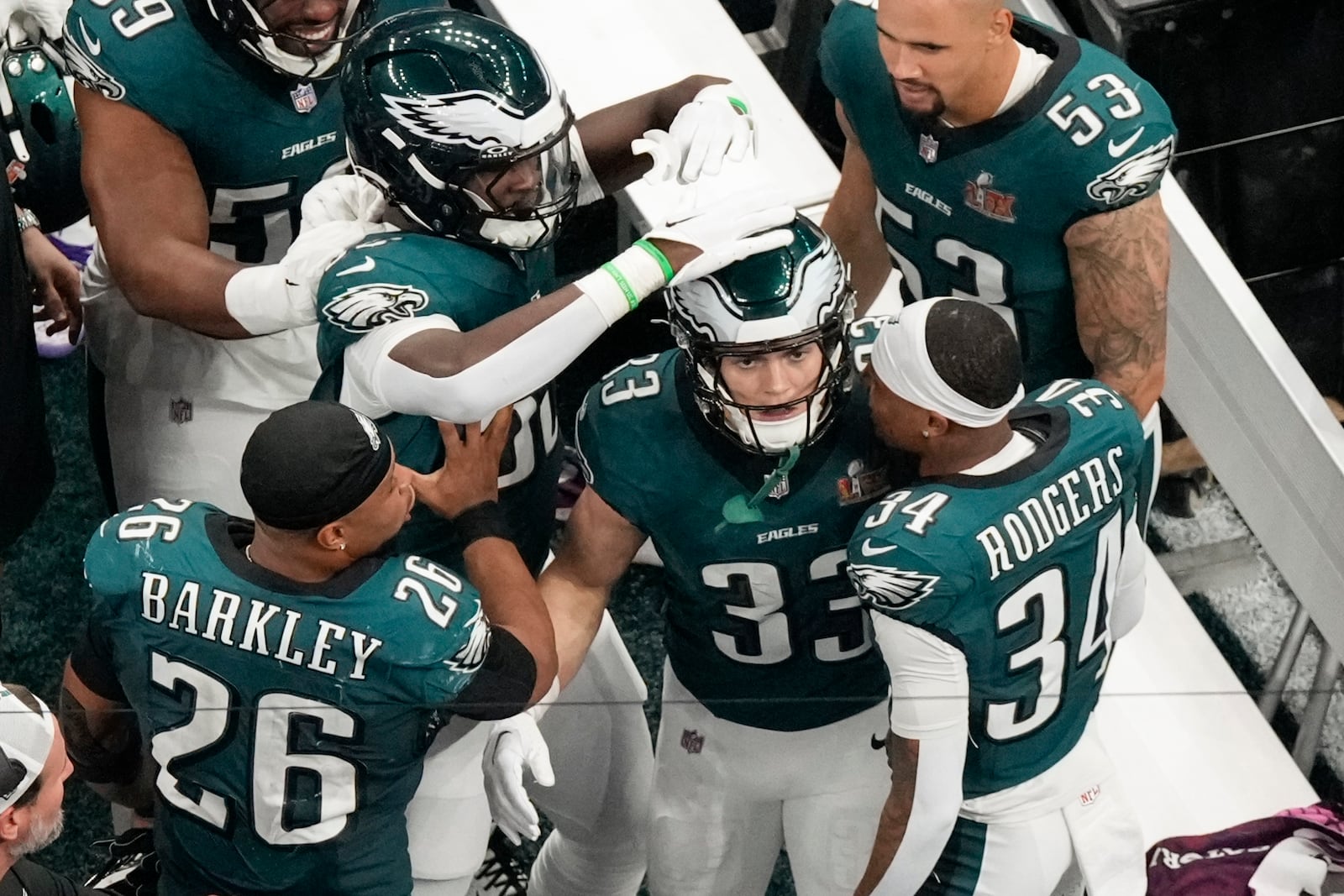 Philadelphia Eagles defensive back Cooper DeJean (33) is congratulated by teammates after returning an interception for a touchdown against the Kansas City Chiefs during the first half of the NFL Super Bowl 59 football game, Sunday, Feb. 9, 2025, in New Orleans. (AP Photo/Godofredo A. Vásquez)