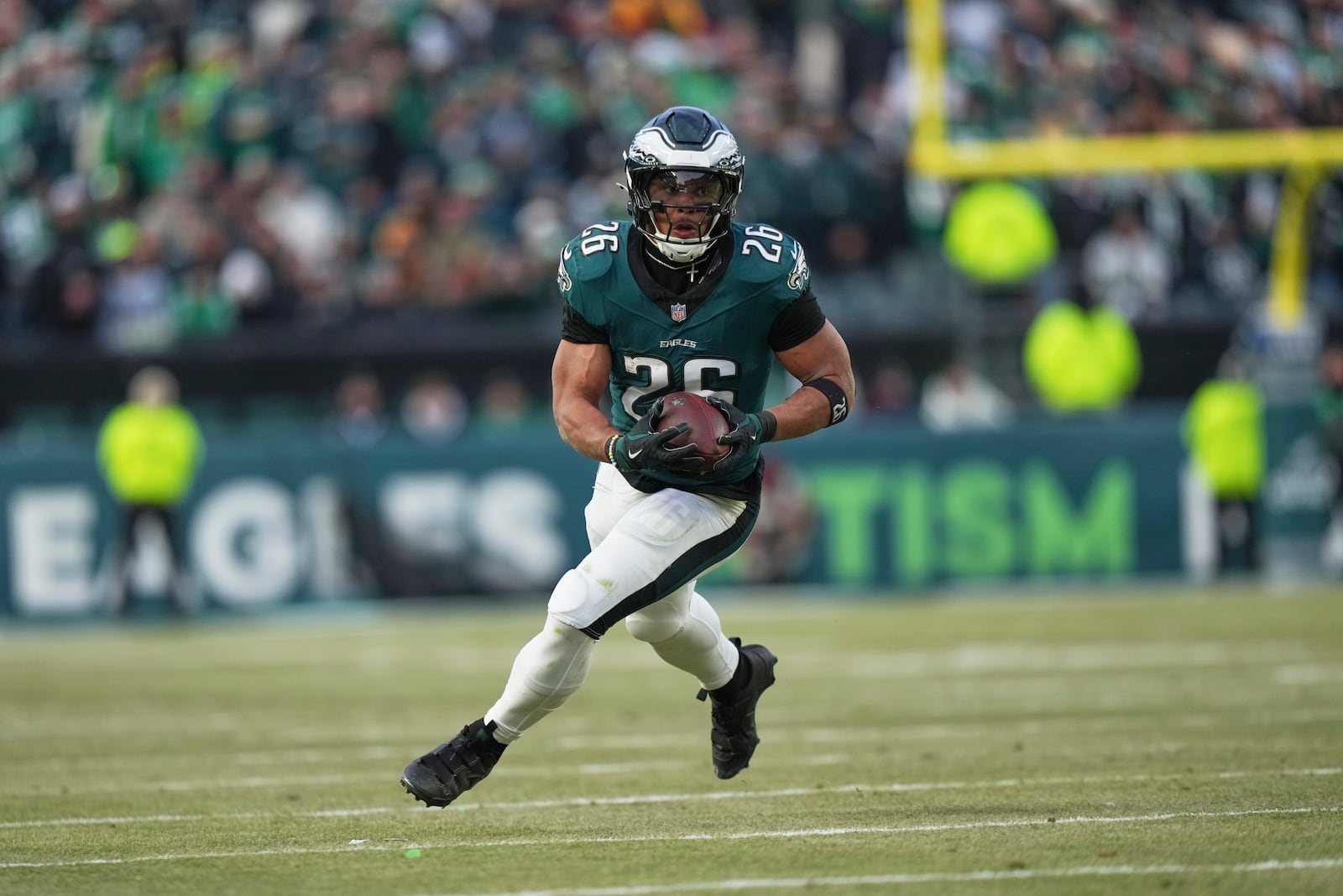 Philadelphia Eagles running back Saquon Barkley rushes for a gain against the Washington Commanders during the first half of the NFC Championship NFL football game, Sunday, Jan. 26, 2025, in Philadelphia. (AP Photo/Matt Slocum)