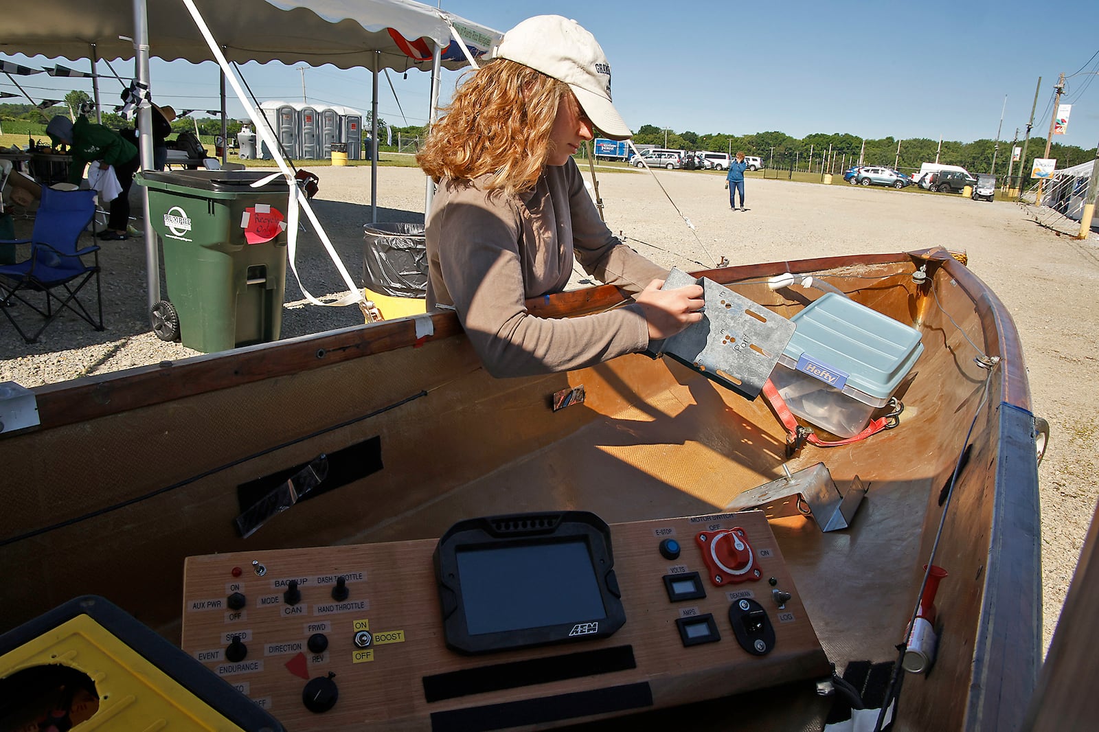 Maria Smith, a student at Cedarville College,  works on her team's boat at Solar Splash 2024 Friday. Teams from eight colleges, from as far away as the University of Puerto Rico, participated in this years event at Champions Park Lake. Solar Splash is the World Championship of Collegiate Solar Boat racing. The five day event starts on June 4 and features five on-the-water competitive events, the