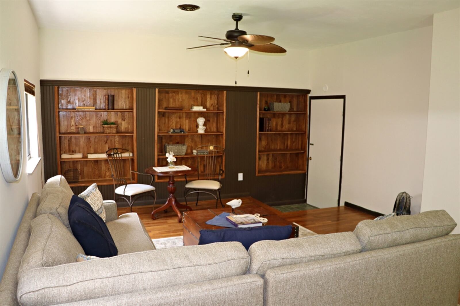 In the family room, built-in storage shelves and artwork display nooks are on one wall.