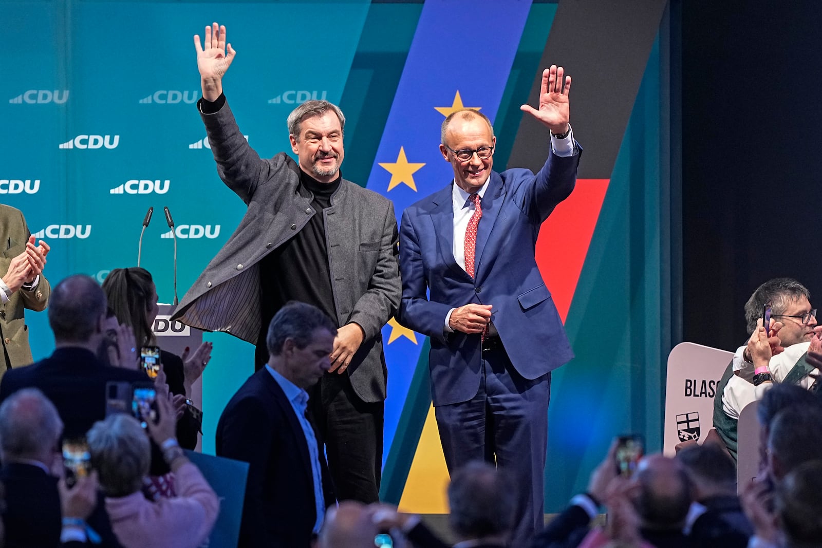 FILE - The top candidate for Chancellor, Friedrich Merz of the Christian Democratic Union (CDU), right, and Bavaria Governor Markus Soeder wave to supporters at a party event in Brilon, Germany, Jan. 19, 2025. (AP Photo/Martin Meissner, File)