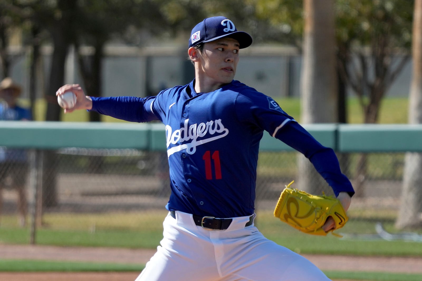 Los Angeles Dodgers pitcher Roki Sasaki (11) throws during his first live bullpen session during spring training baseball practice, Wednesday, Feb. 19, 2025, in Phoenix. (AP Photo/Darryl Webb)