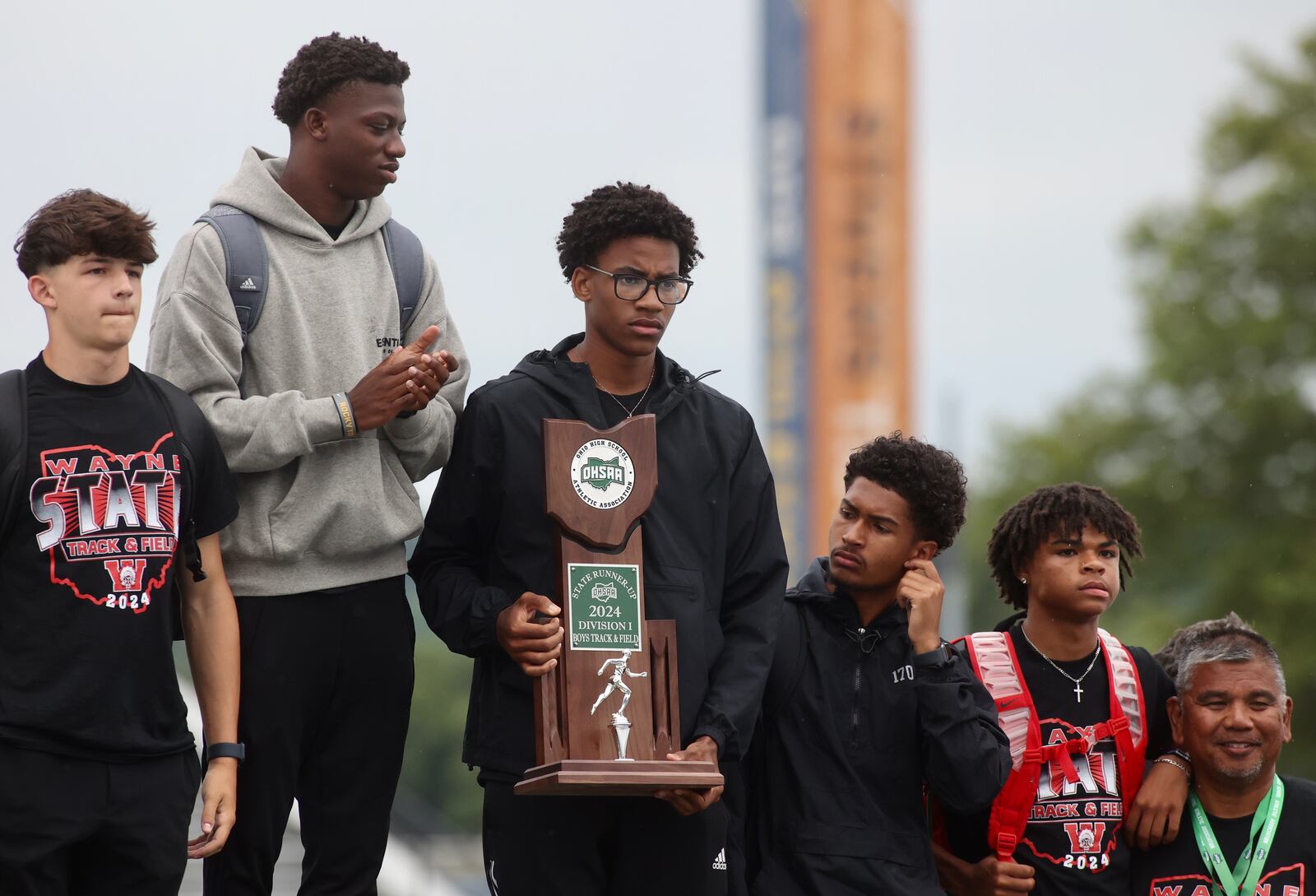 Wayne's boys track team holds the runner-up trophy at the Division I state track and field meet on Saturday, June 1, 2024, at Welcome Stadium in Dayton. David Jablonski/Staff