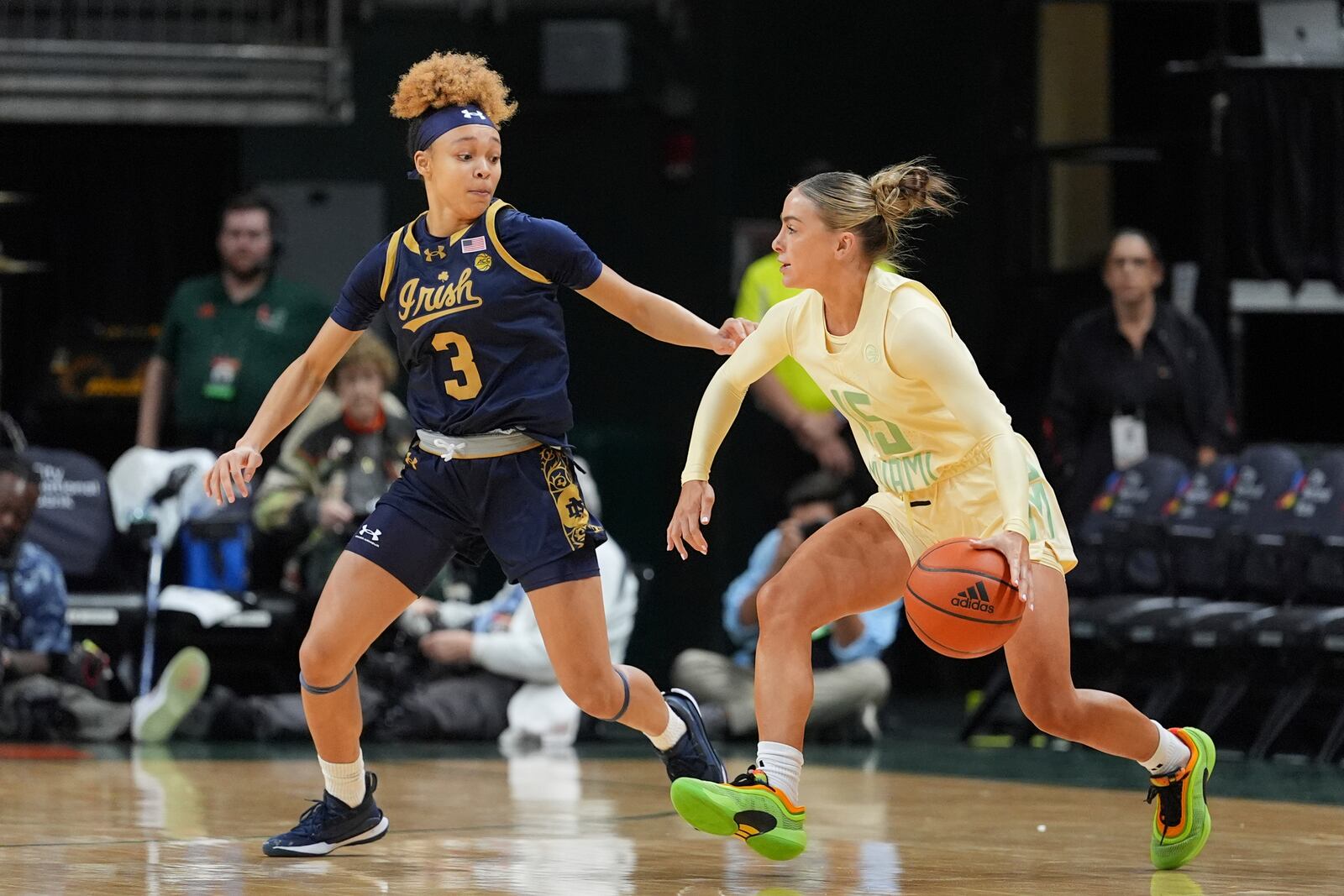 Miami guard Hanna Cavinder (15) drives forward, defended by Notre Dame guard Hannah Hidalgo (3), in the first half of an NCAA college basketball game, Thursday, Feb. 20, 2025, in Coral Gables, Fla. (AP Photo/Rebecca Blackwell)